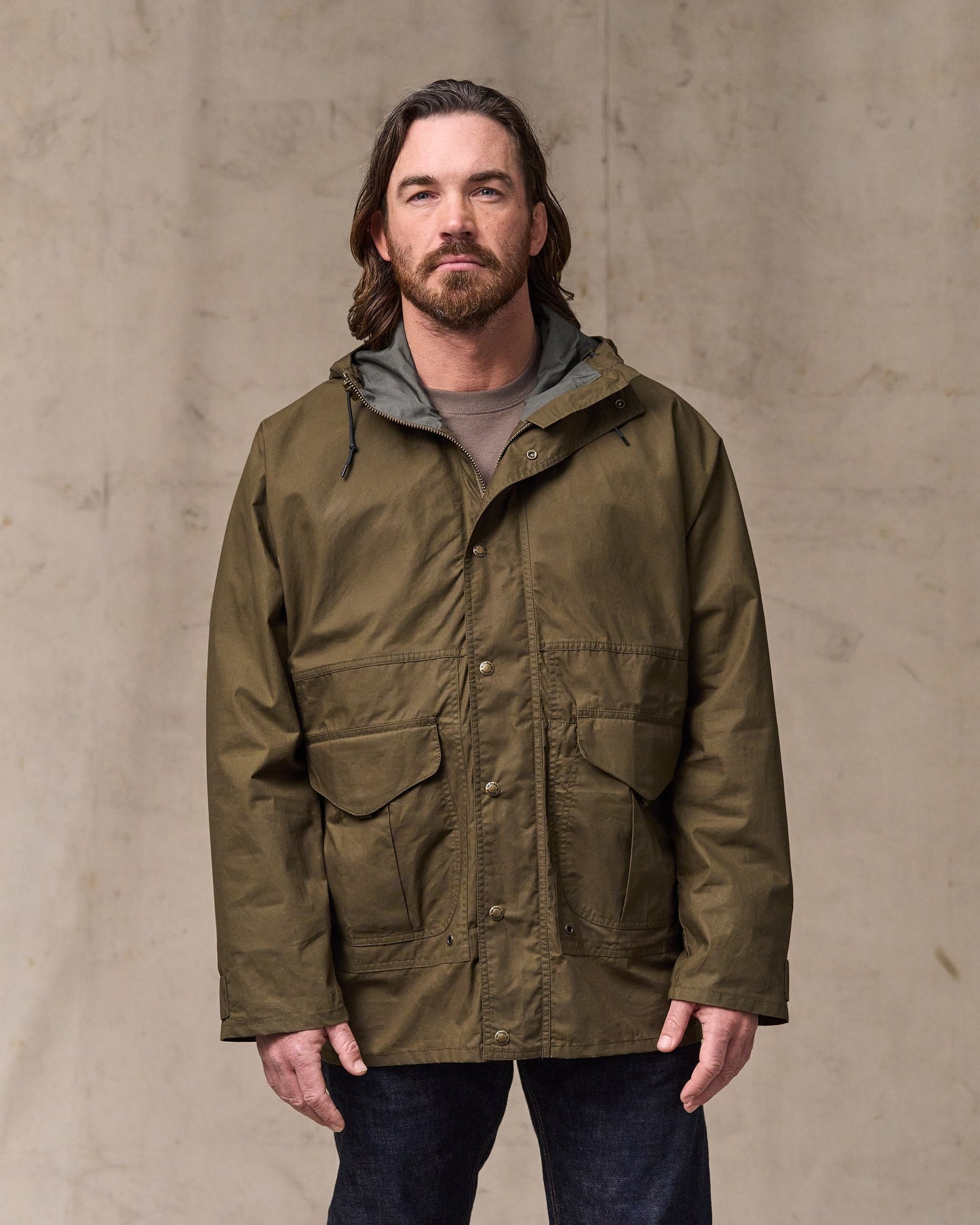 image of a model wearing Filson's Dry Wax Omak Coat - Burnt Olive|Model is 6'1" wearing a size medium