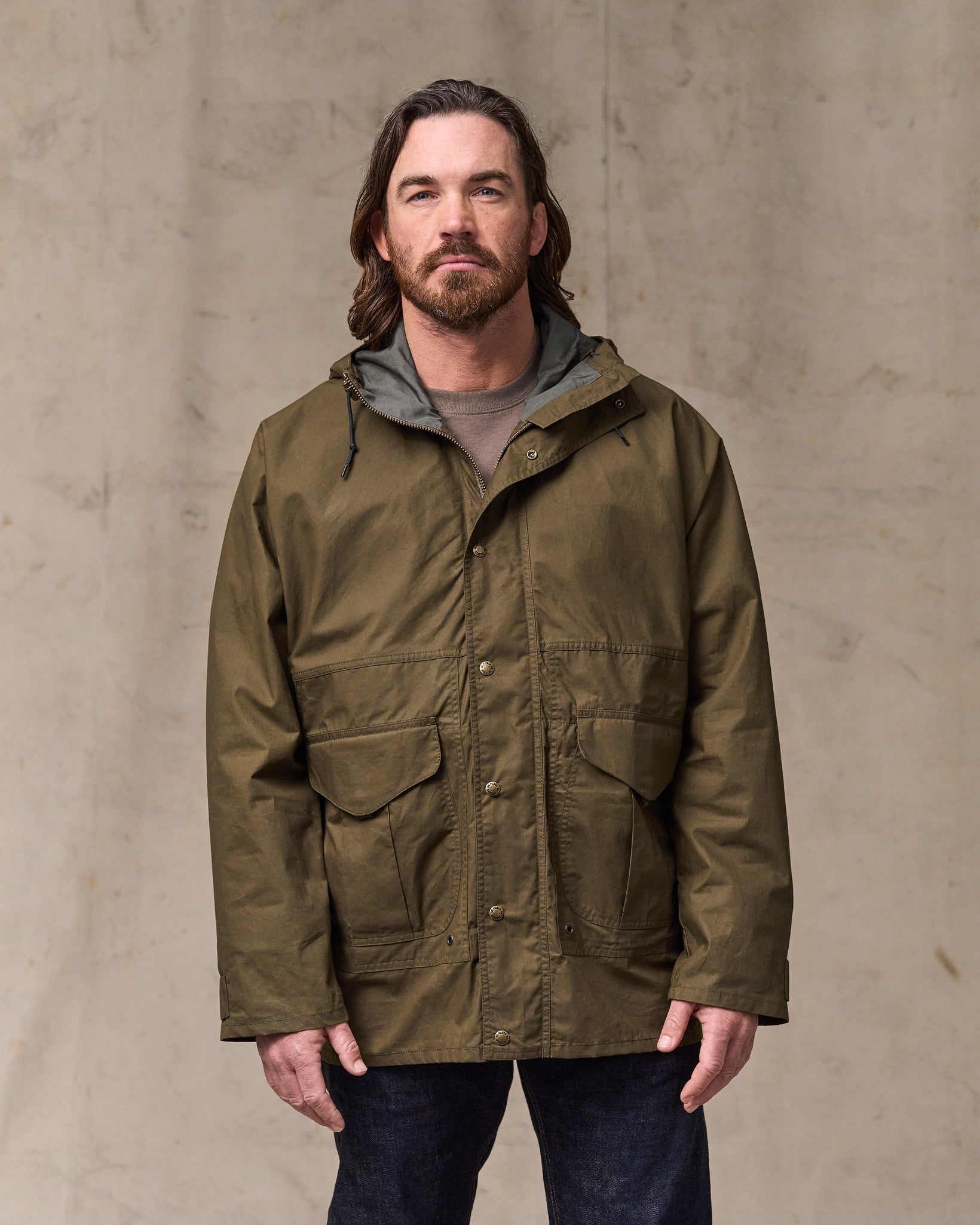 image of a model wearing Filson's Dry Wax Omak Coat - Burnt Olive