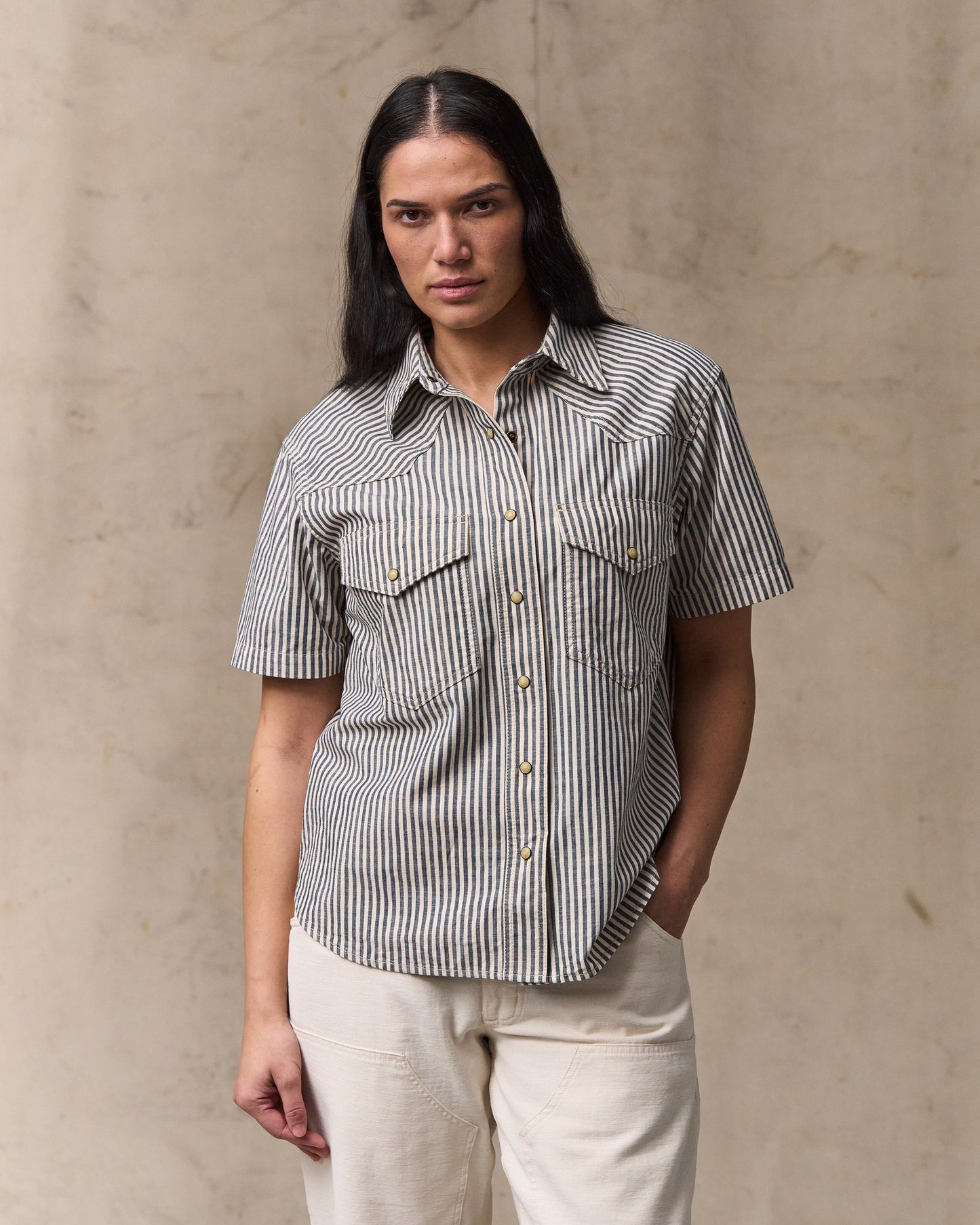 image of a model wearing Filson's Women's Short Sleeve Chambray Western Shirt - Indigo / Natural|Model is 5'10" wearing a size medium