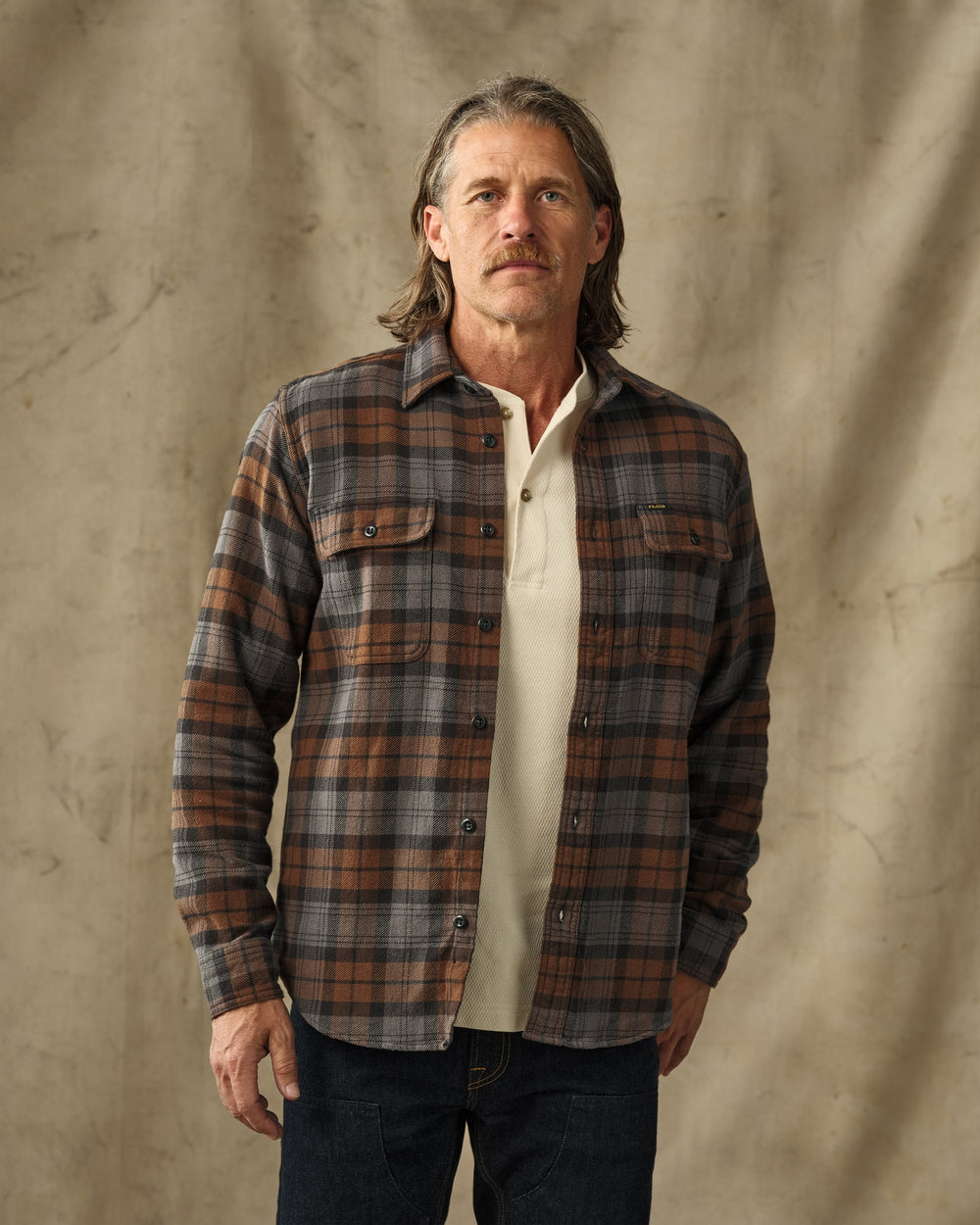 image of a model wearing Filson's Vintage Flannel Work Shirt - Brown / Charcoal Plaid