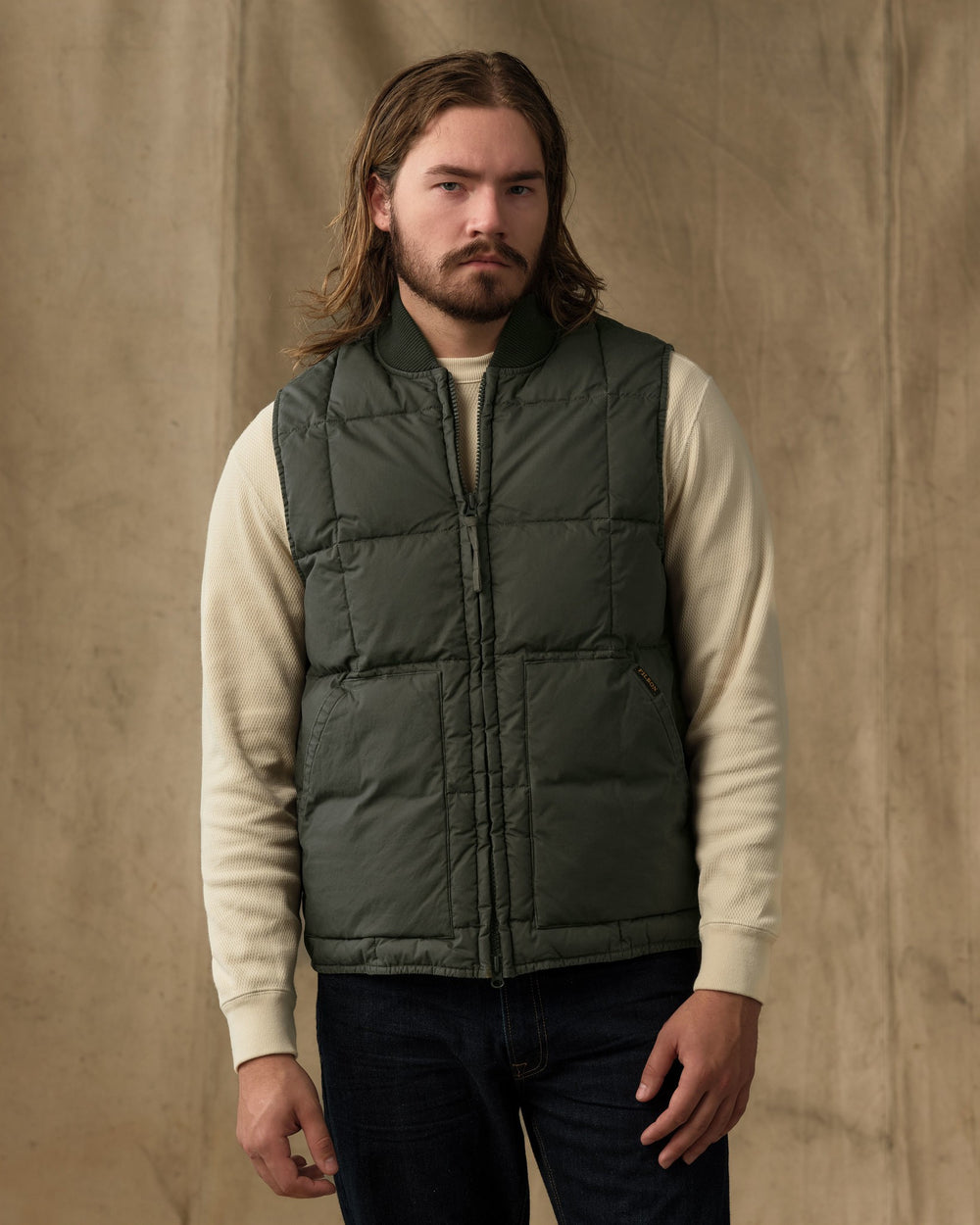 image of a model wearing Filson's Heritage Cotton Down Vest - Beluga