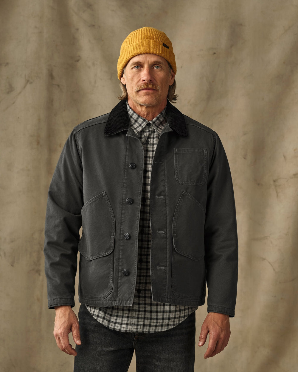 image of a model wearing Filson's Insulated Canvas Outfitter Jacket - Peat