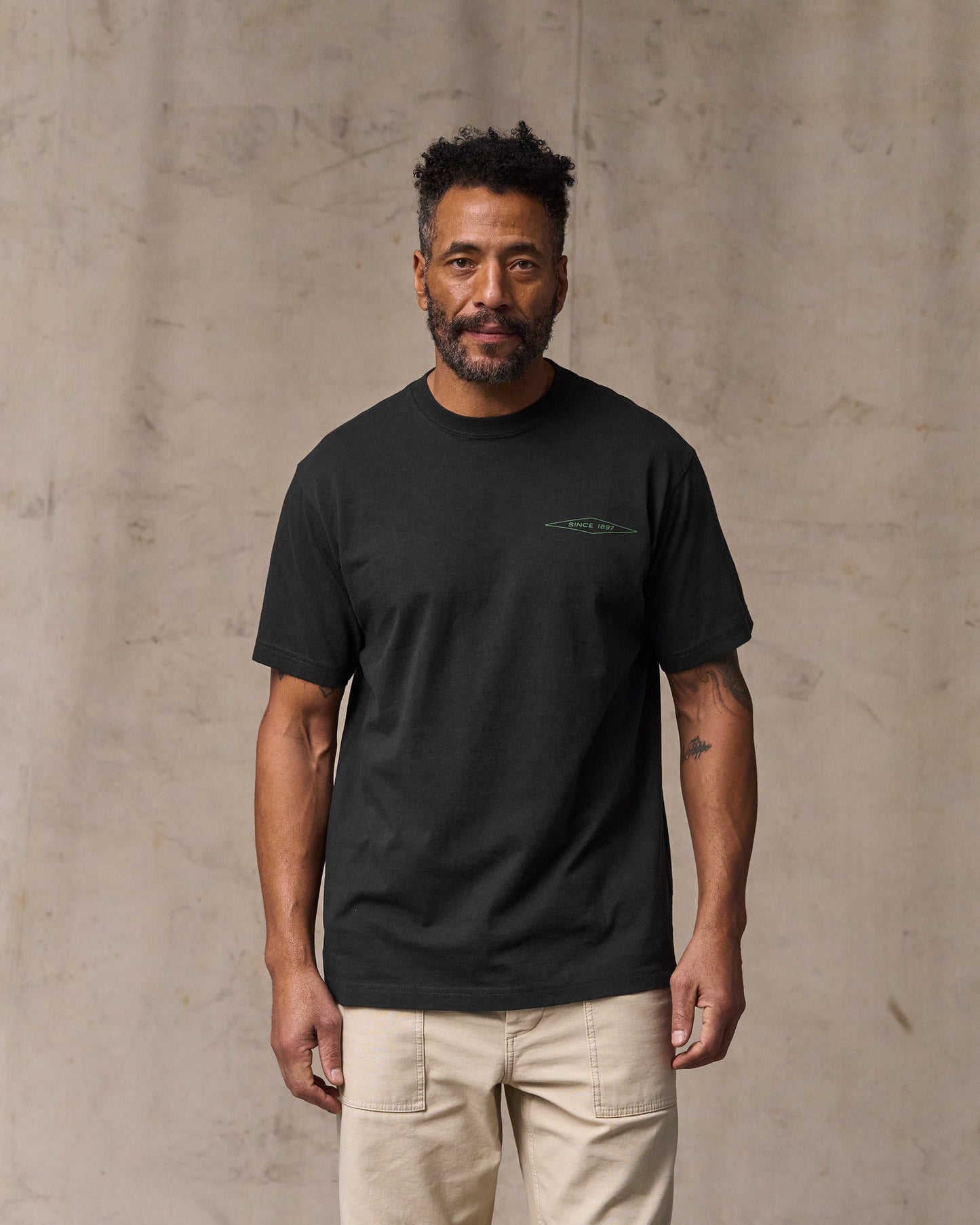 image of a model wearing Filson's Diamond Graphic T-shirt - Black|Model is 6'2" wearing a size medium