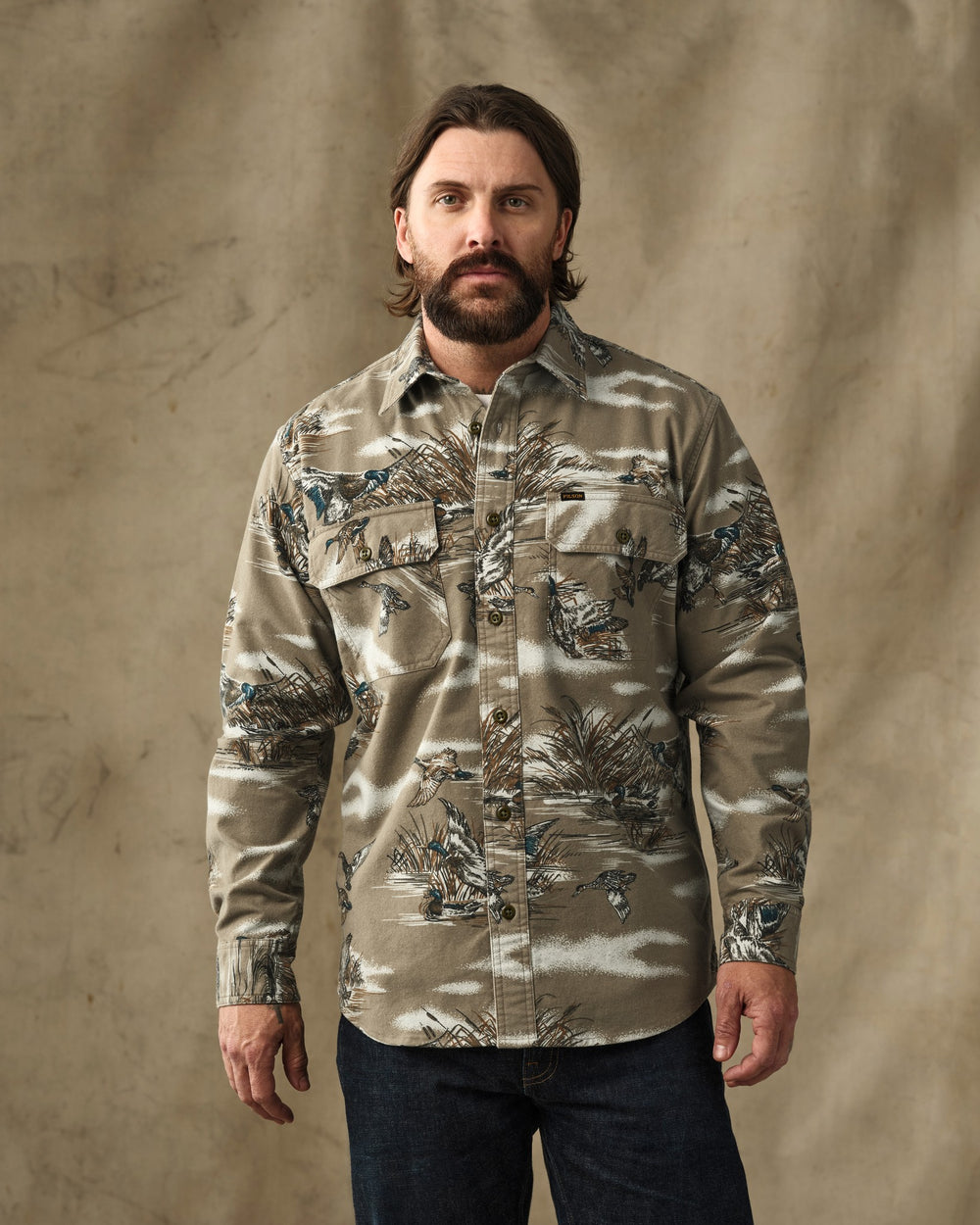 image of a model wearing Filson's Field Flannel Shirt - Marsh Olive Print