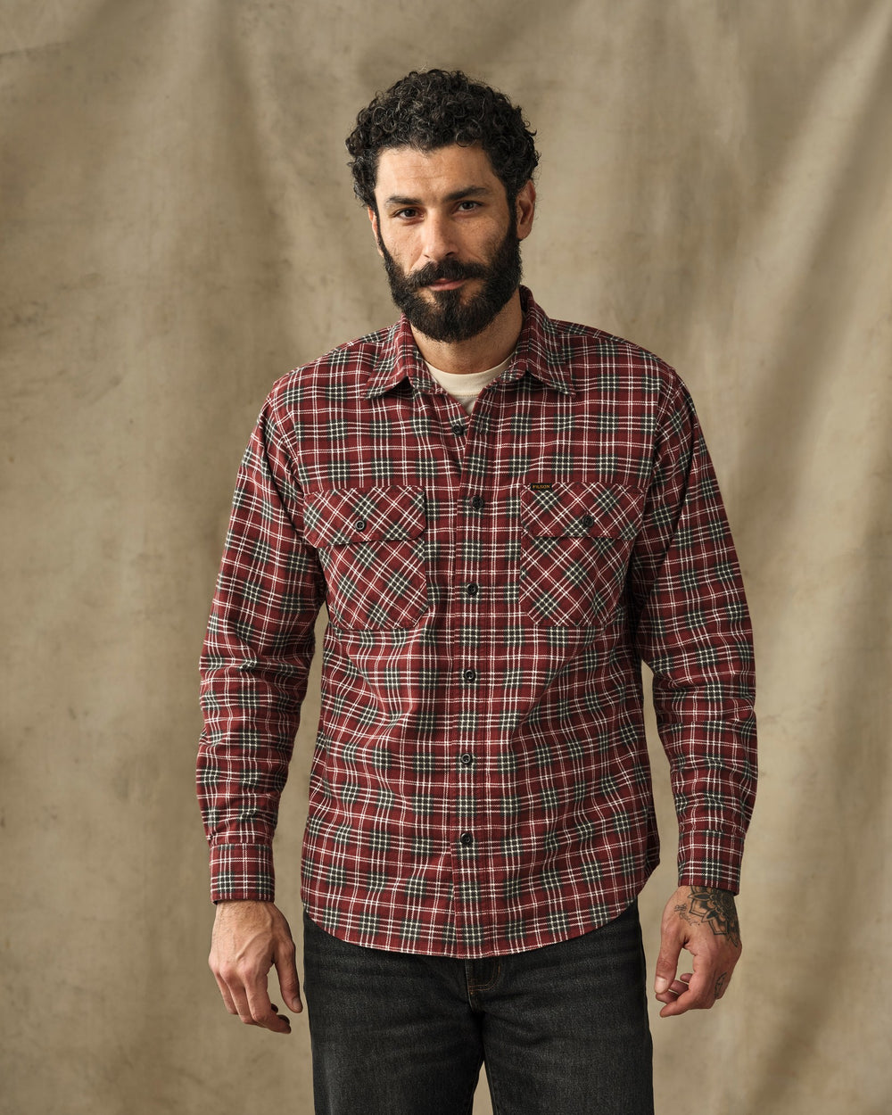 image of a model wearing Filson's Field Flannel Shirt - Russet Red Plaid