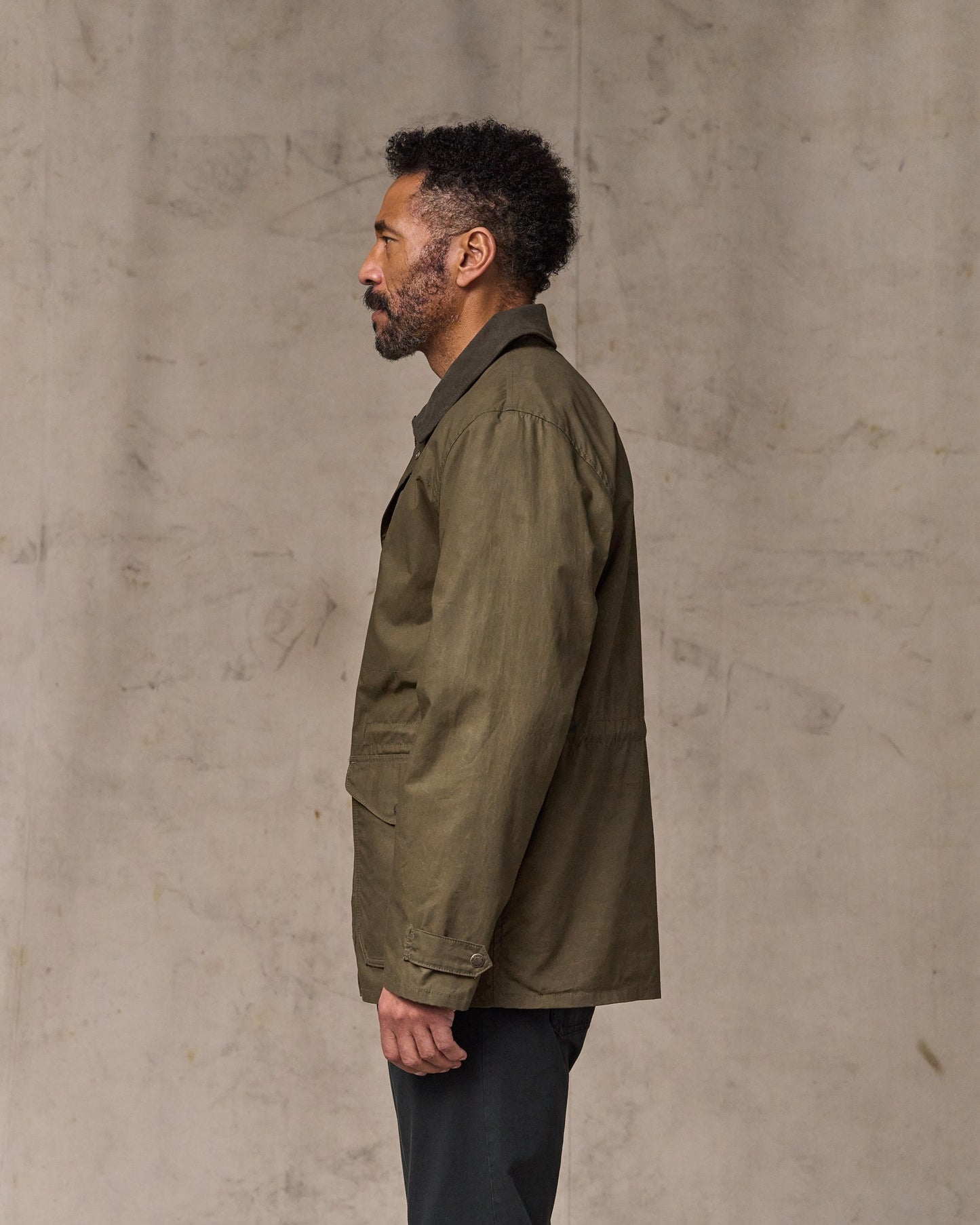 image of a model wearing Filson's Dry Wax Mile Marker Coat - Burnt Olive