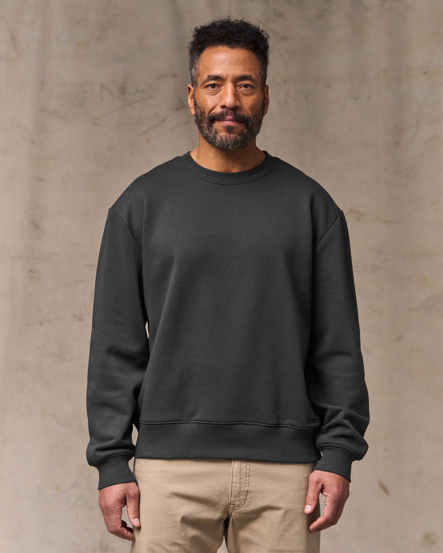 image of a model wearing Filson's Northwest Crewneck Sweatshirt - Faded Black|Model is 6'2" wearing a size medium
