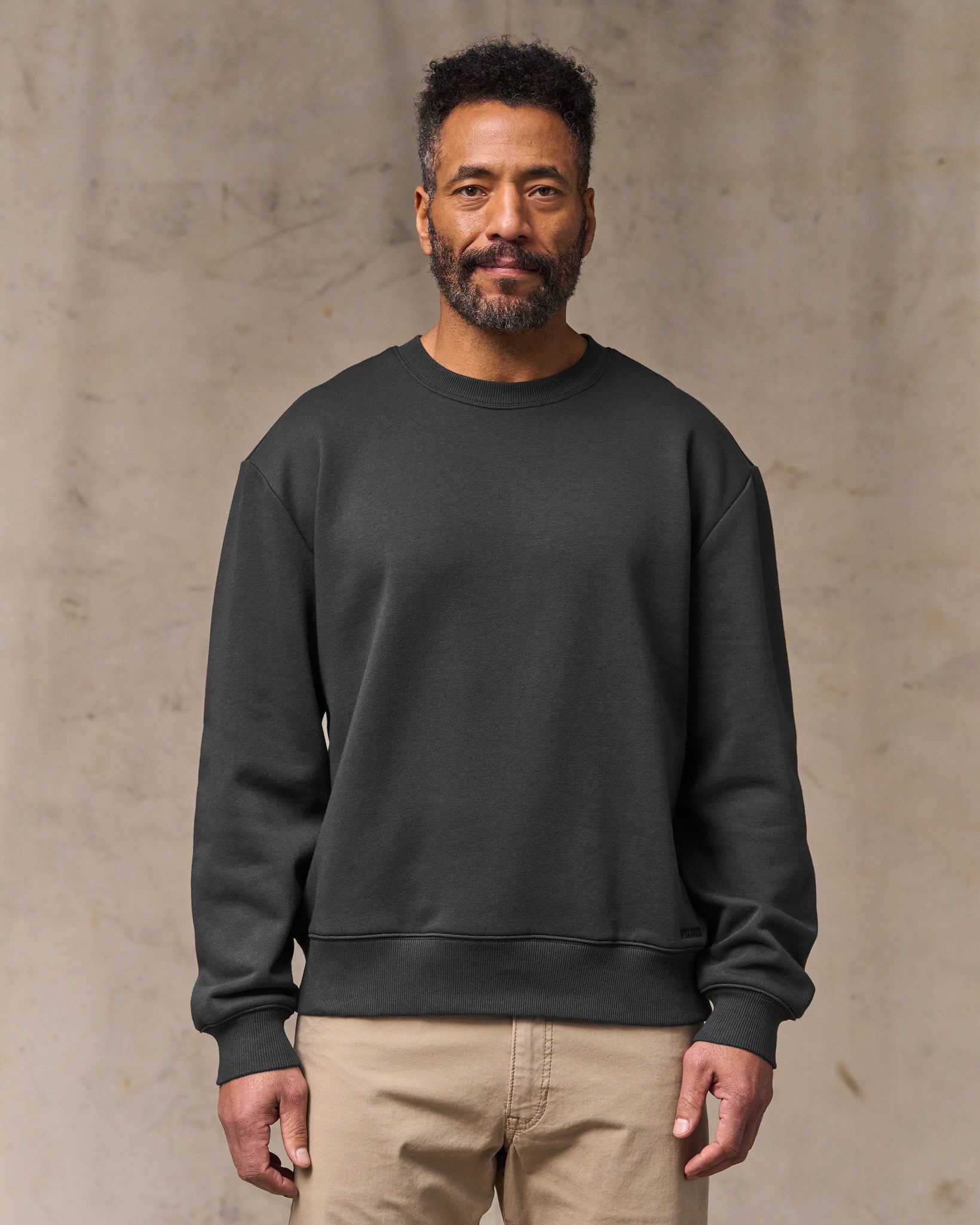 image of a model wearing Filson's Northwest Crewneck Sweatshirt - Faded Black