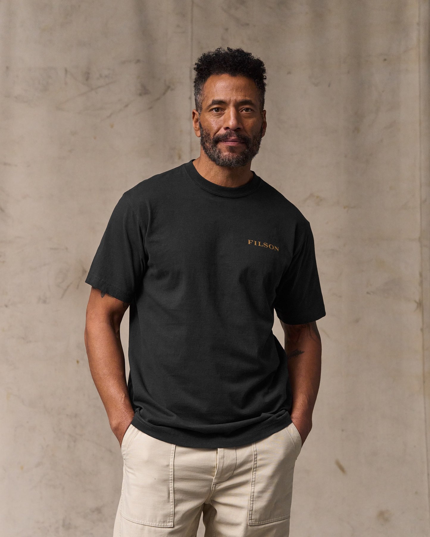 image of a model wearing Filson's Scenic Graphic T-shirt - Black|Model is 6'2" wearing a size medium