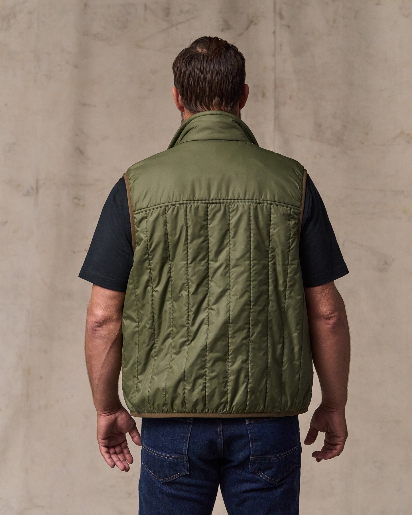 image of a model wearing Filson's Ultralight Vest - Dark Olive Drab