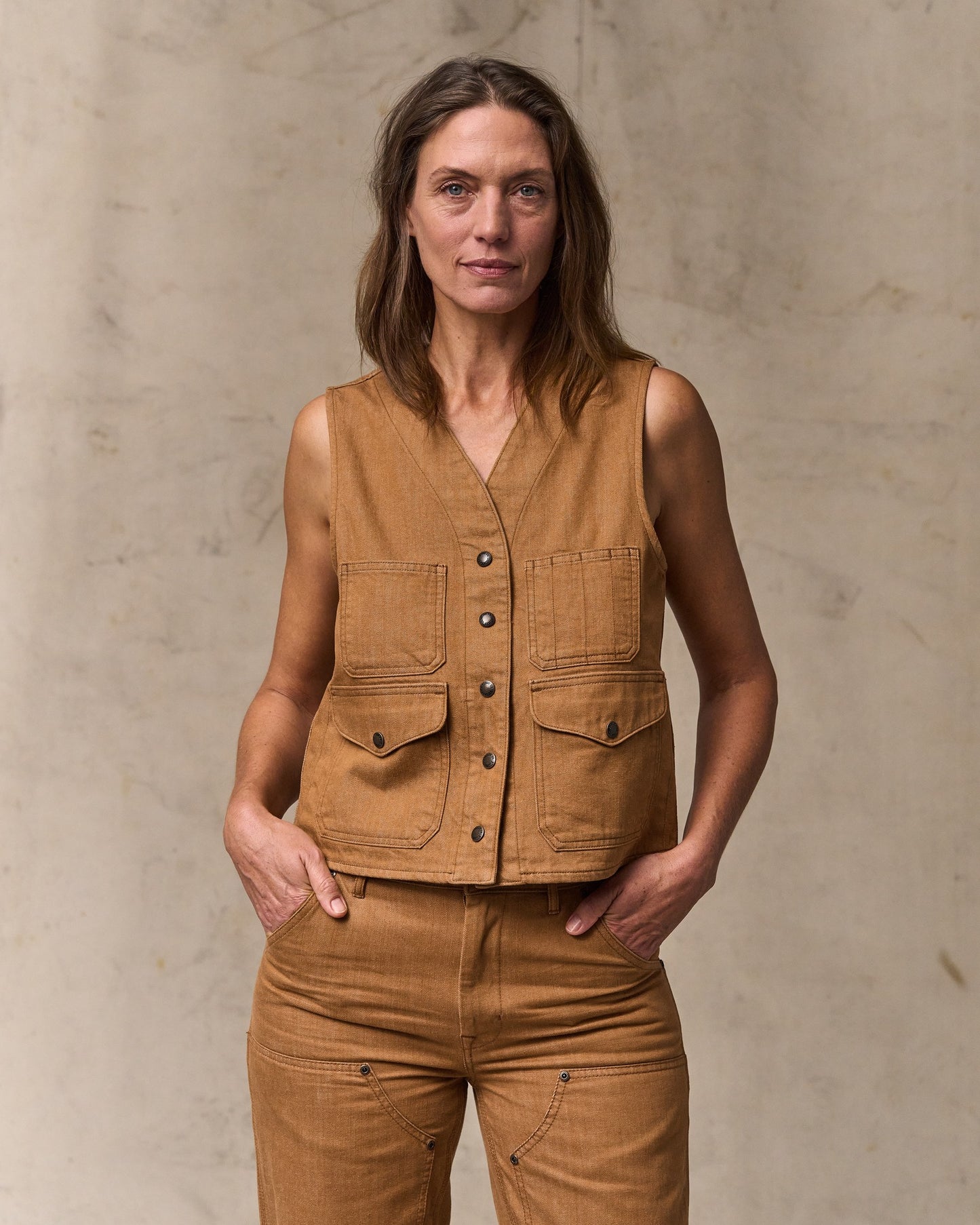 image of a model wearing Filson's Women's Archive Cruiser Vest - Harvest Tan|Model is 5'10" wearing a size medium|Model is 5'10" wearing a size medium