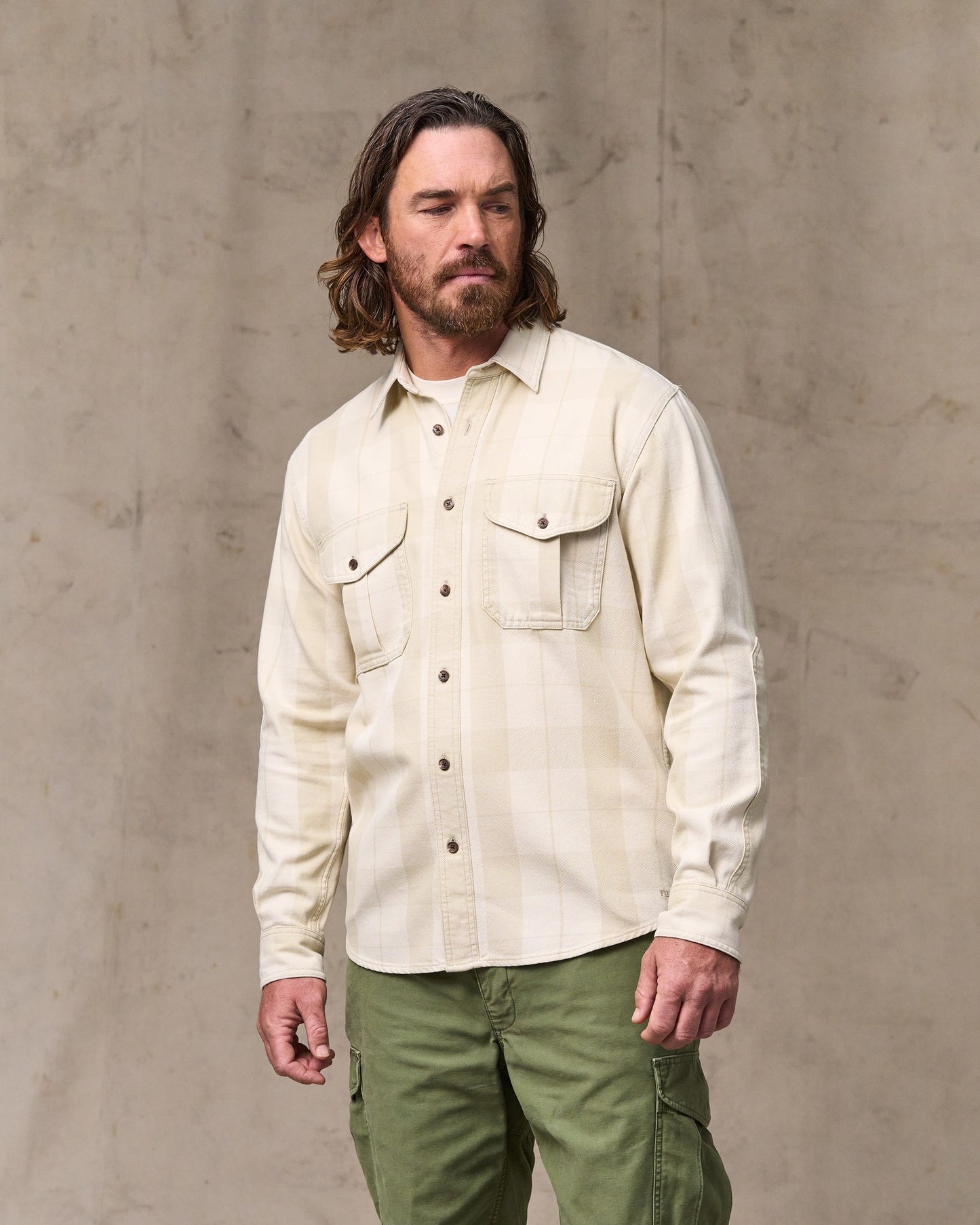 image of a model wearing Filson's Vintage Wash Alaskan Guide Shirt - Sand / Stone Plaid|Model is 6'1" wearing a size medium