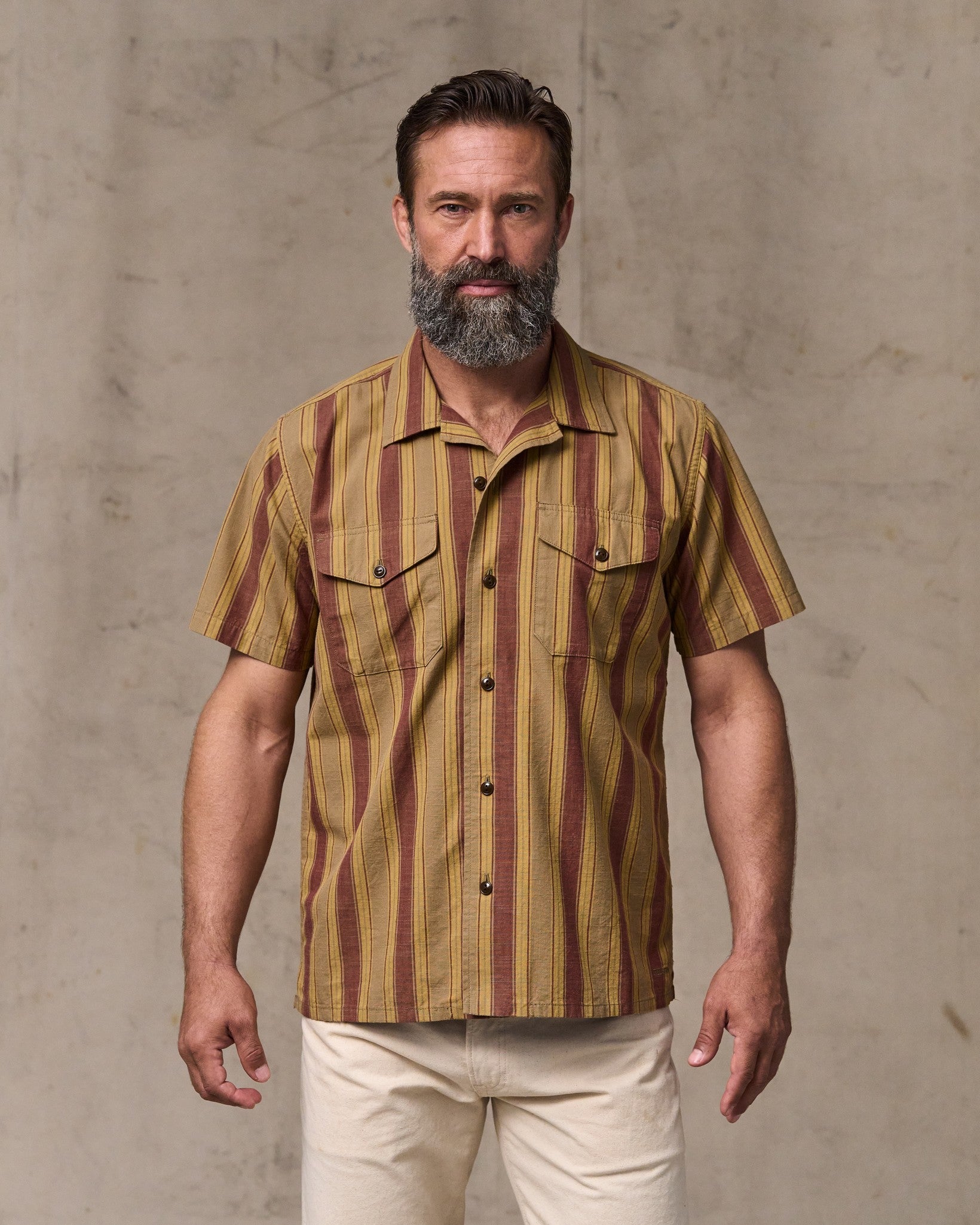 image of a model wearing Filson's Chambray Camp Shirt - Brick / Tan