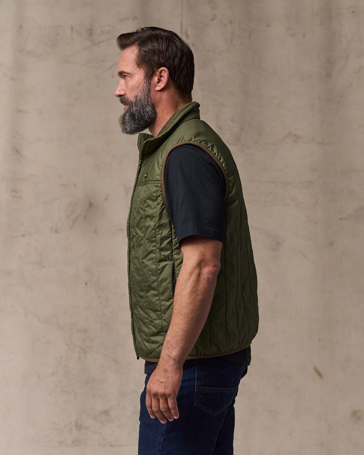 image of a model wearing Filson's Ultralight Vest - Dark Olive Drab