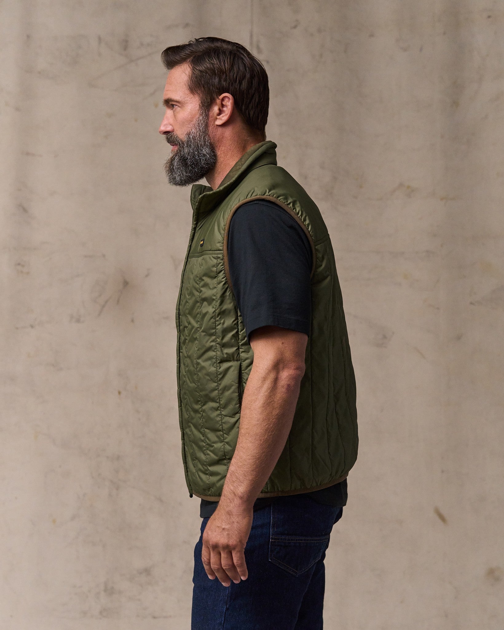 image of a model wearing Filson's Ultralight Vest - Dark Olive Drab