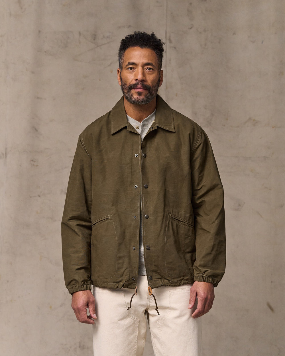 image of a model wearing Filson's Dry Wax Windbreaker - Military Olive