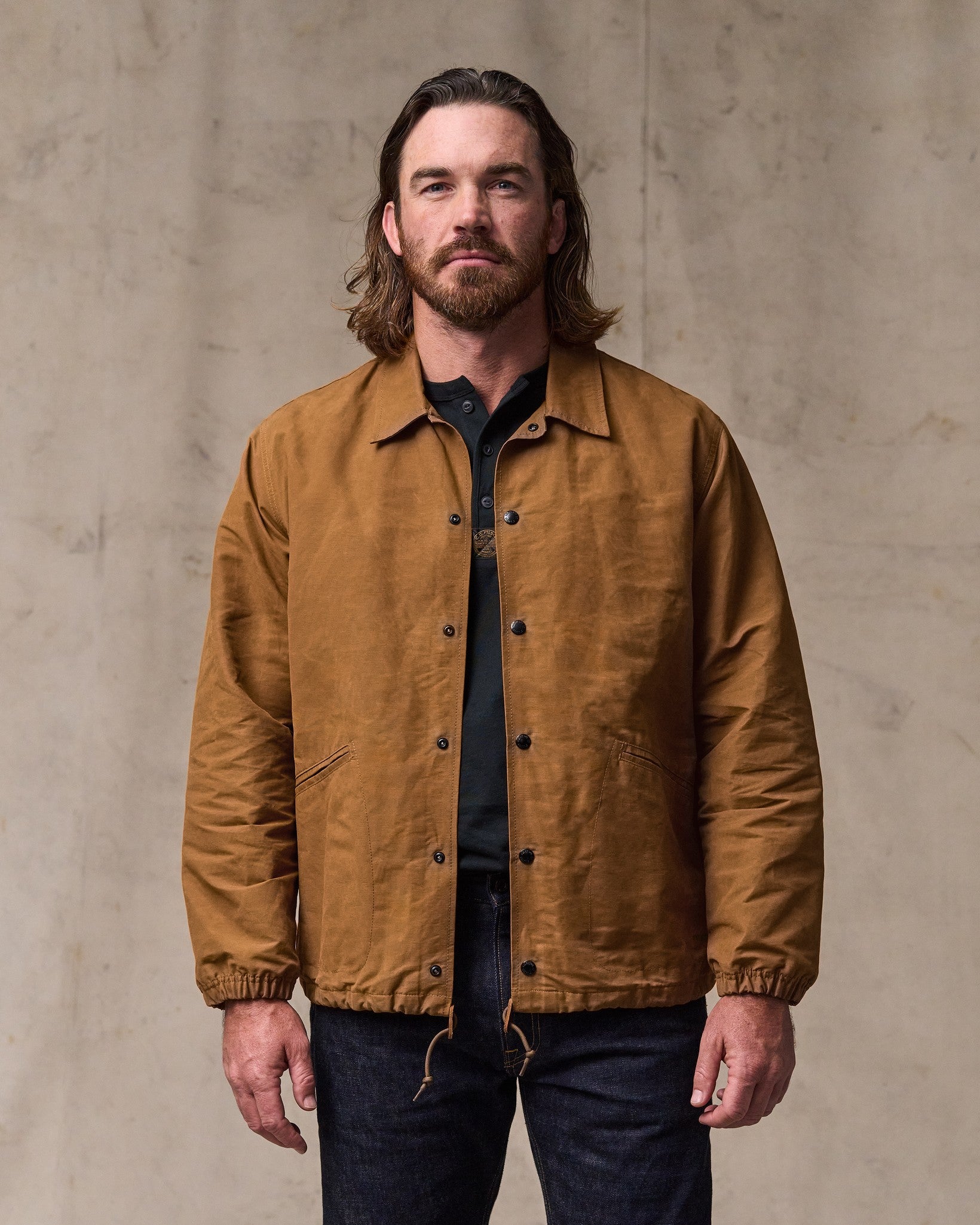 image of a model wearing Filson's Dry Wax Windbreaker - Harvest Tan