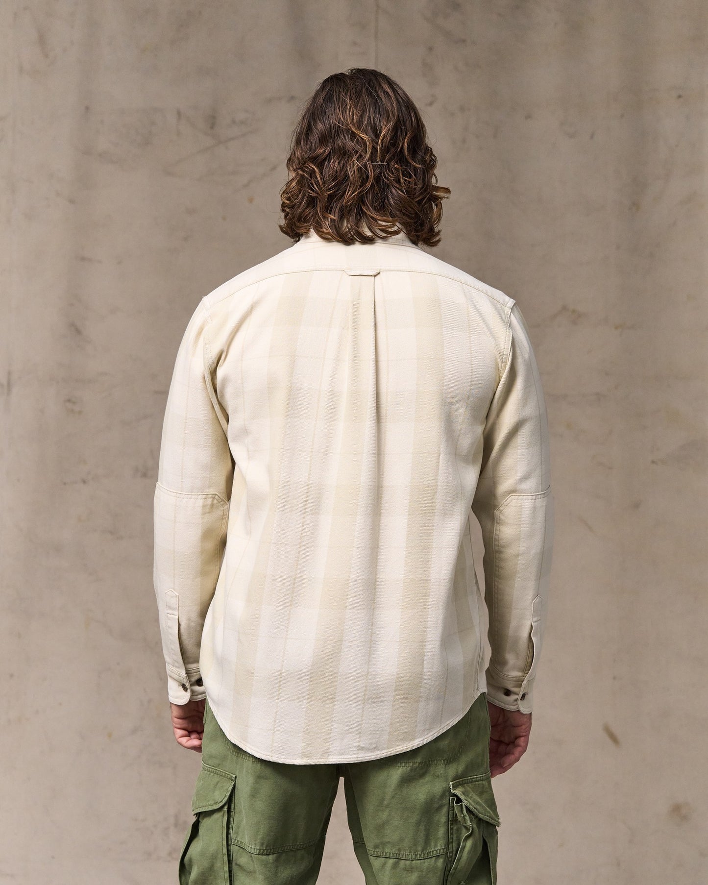 image of a model wearing Filson's Vintage Wash Alaskan Guide Shirt - Sand / Stone Plaid