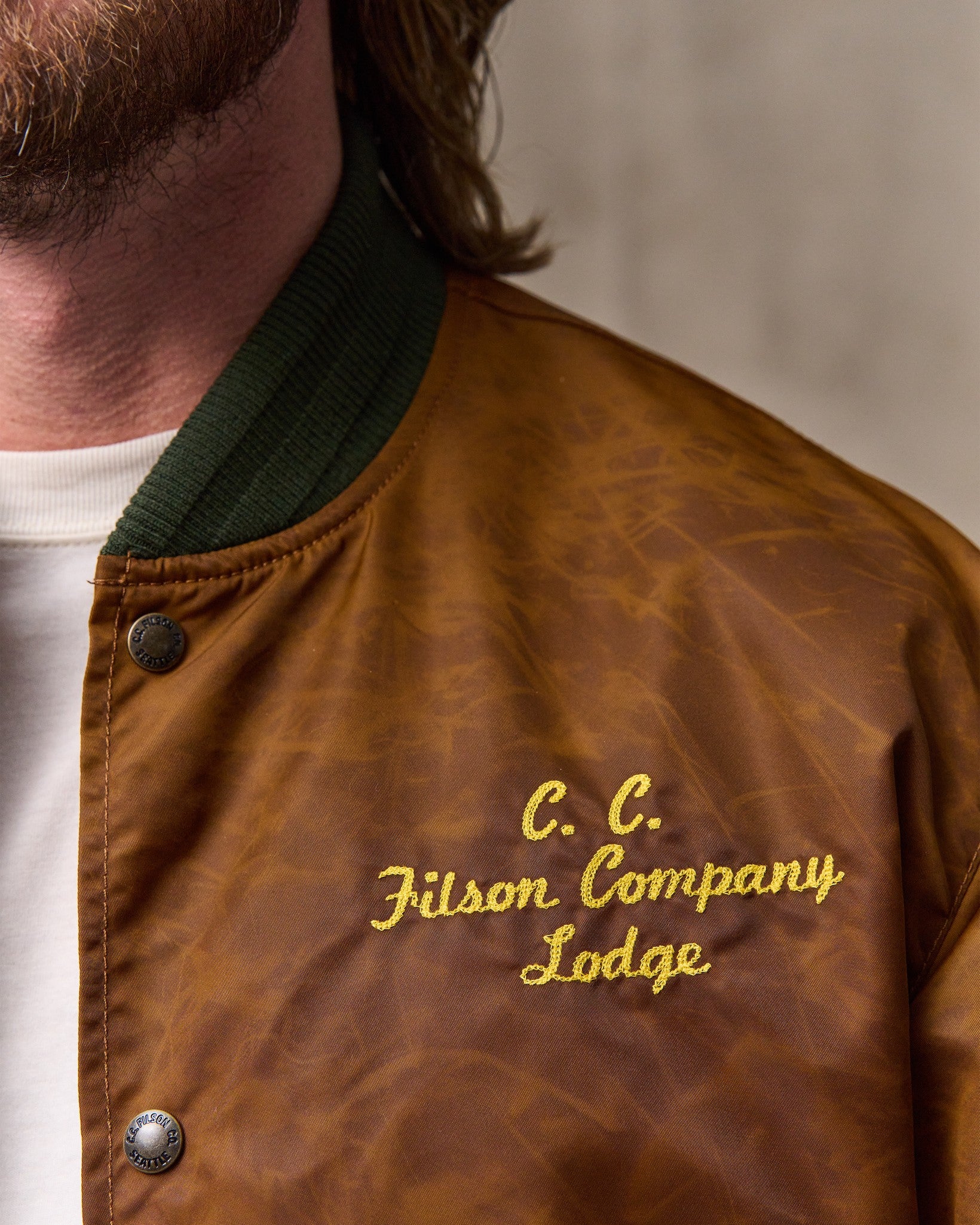 image of a model wearing Filson's Embroidered Montlake Jacket - Whiskey