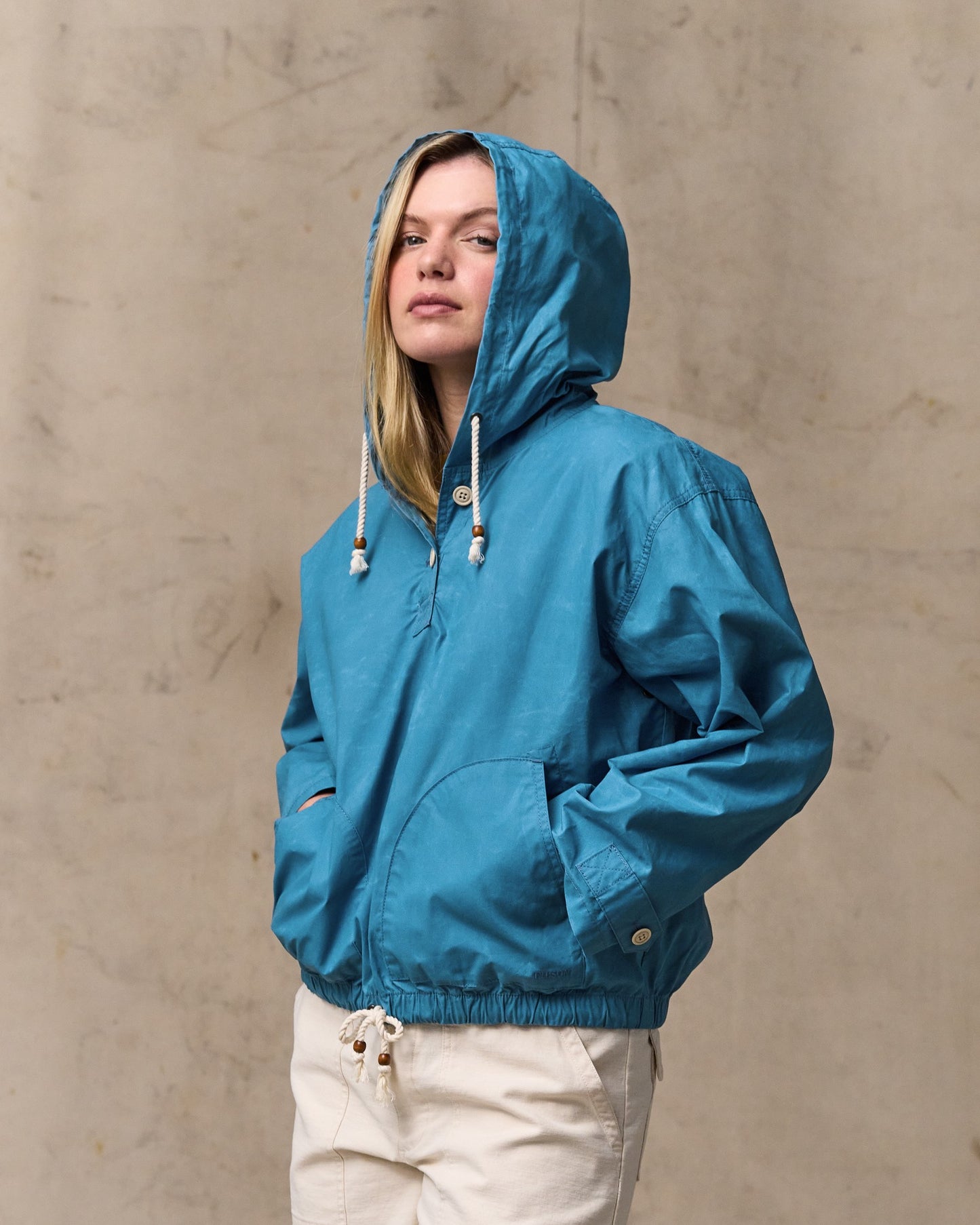 image of a model wearing Filson's Women's Dry Wax Hooded Popover - Marine Blue