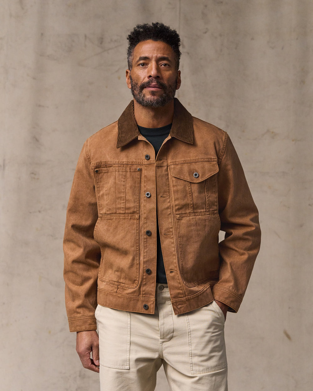 image of a model wearing Filson's Rustic Canvas Short Cruiser Jacket - Whiskey