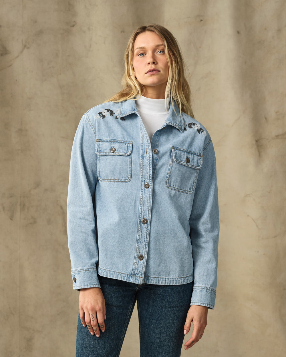 image of a model wearing Filson's Women's Embroidered Denim Shirt - Pale Indigo