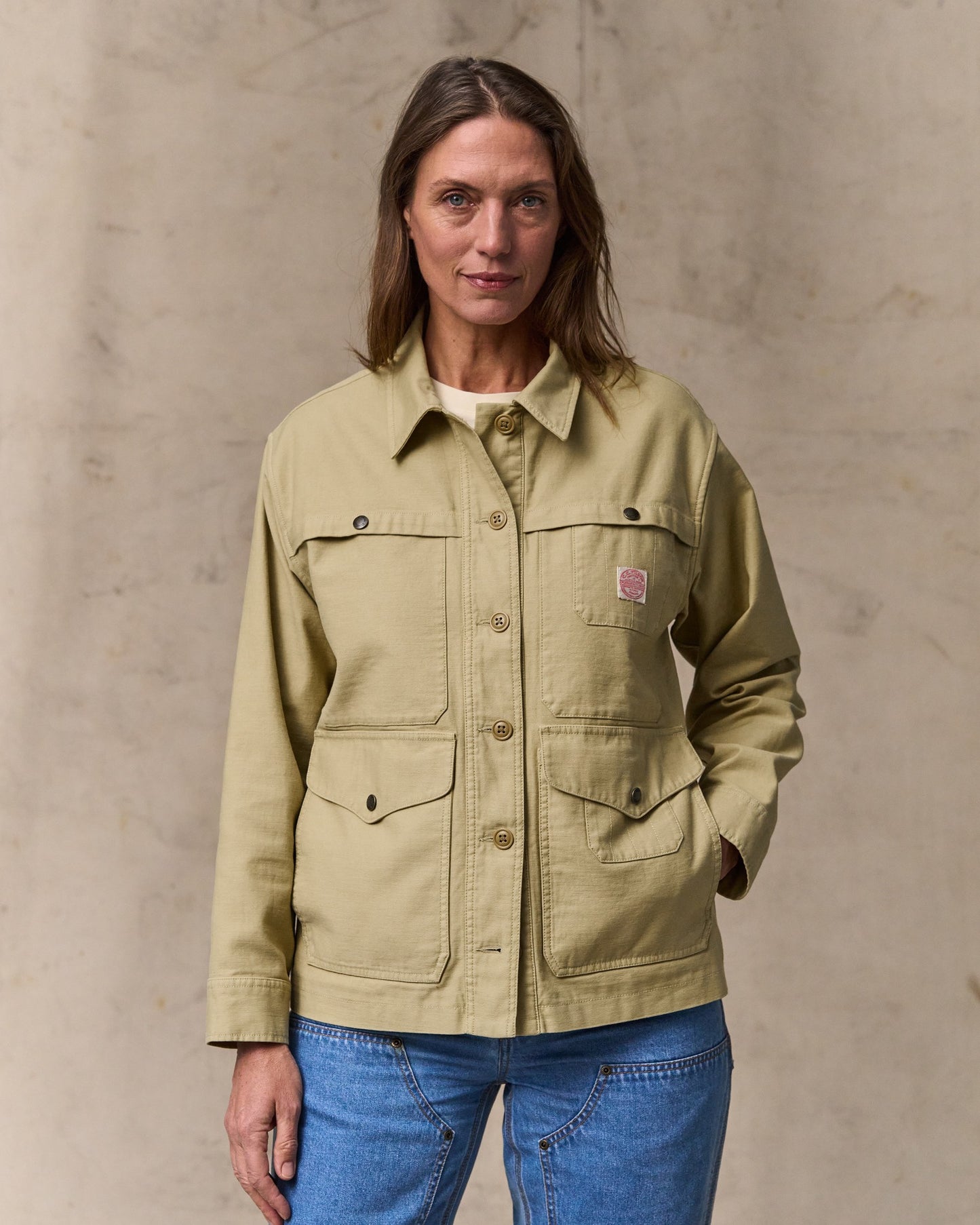 image of a model wearing Filson's Women's Reverse Sateen Cruiser Jacket - Antique Khaki|Model is 5'10" wearing a size medium