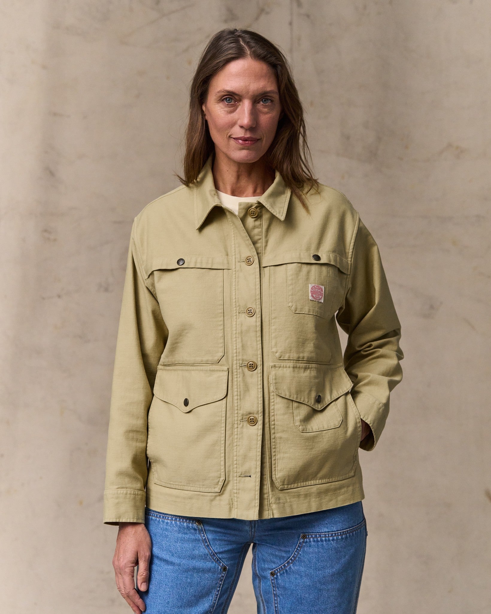 image of a model wearing Filson's Women's Reverse Sateen Cruiser Jacket - Antique Khaki