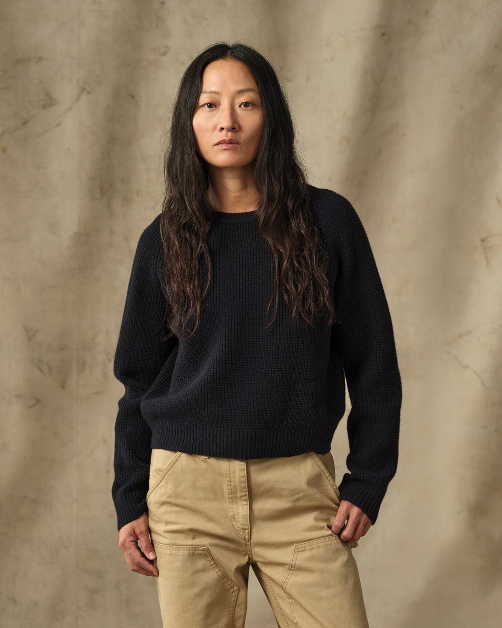 image of a model wearing Filson's Women's Waffle Knit Merino Sweater - Dark Navy