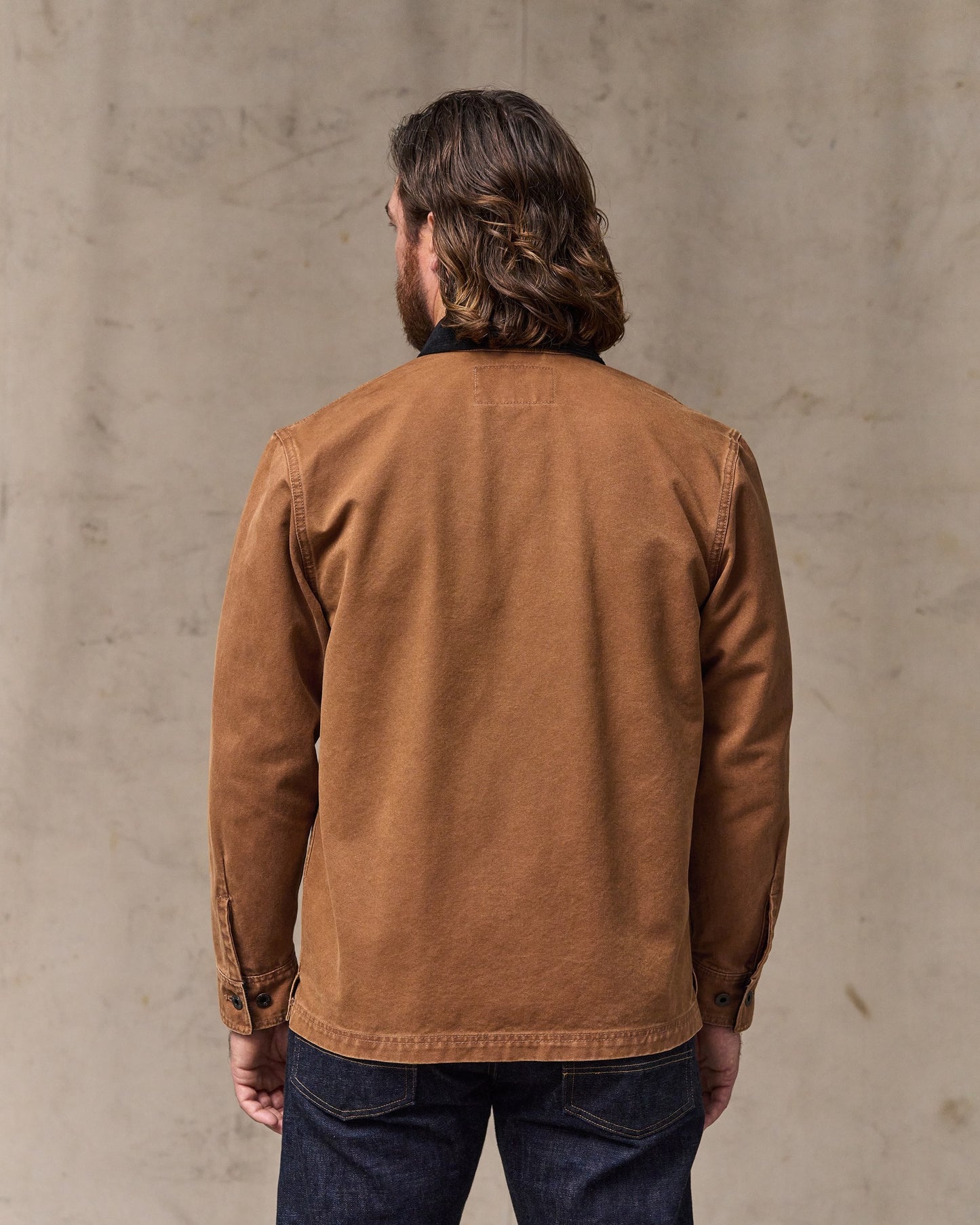 image of a model wearing Filson's Rustic Canvas Jac-shirt - Whiskey