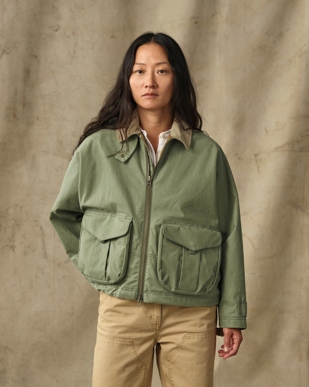 image of a model wearing Filson's Women's Shelter Cloth Short Work Jacket - Sage Olive