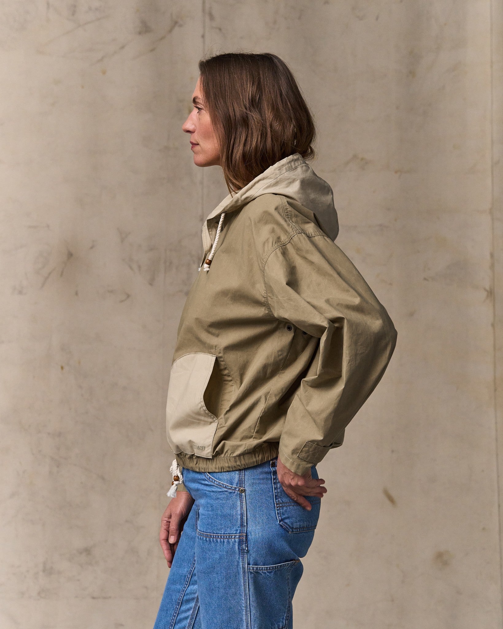image of a model wearing Filson's Women's Dry Wax Hooded Popover - Khaki / Quail Tan