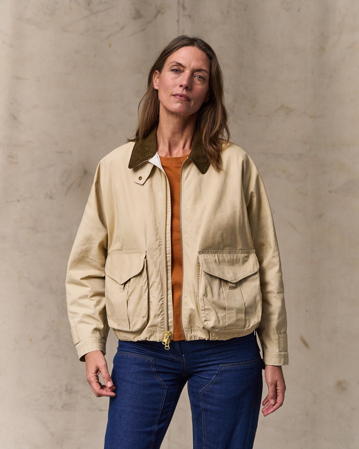image of a model wearing Filson's Women's Dry Wax Short Work Jacket - Quail Tan|Model is 5'10" wearing a size medium