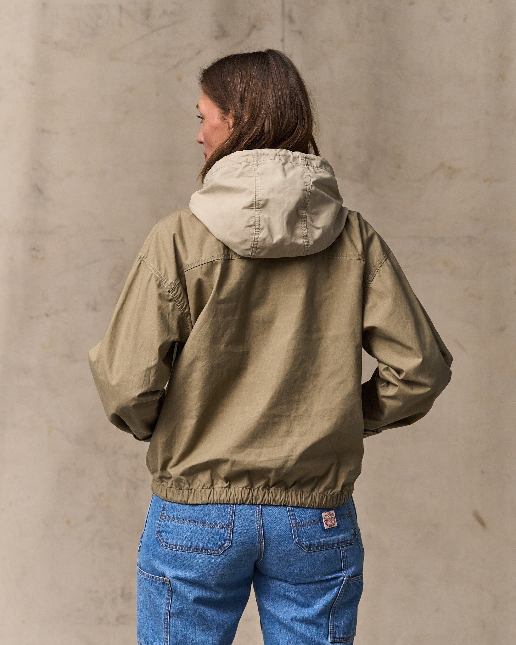image of a model wearing Filson's Women's Dry Wax Hooded Popover - Khaki / Quail Tan