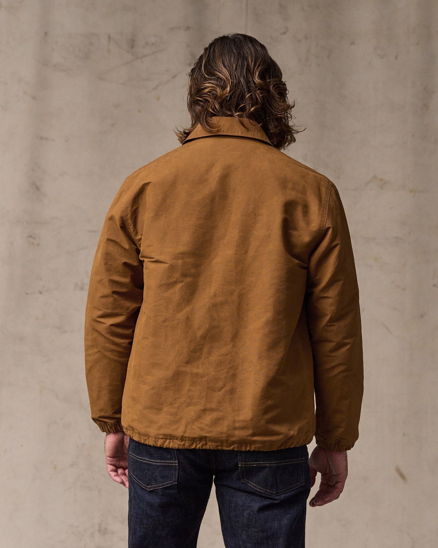 image of a model wearing Filson's Dry Wax Windbreaker - Harvest Tan