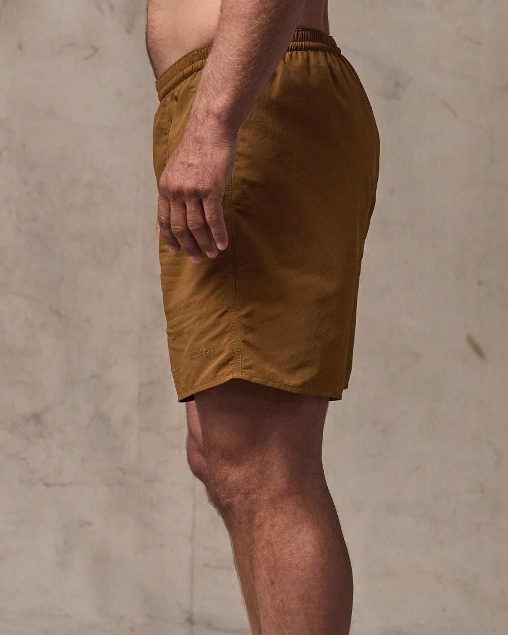 image of a model wearing Filson's Oxbow Lake Trunks - Whiskey