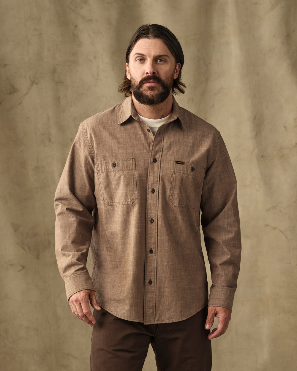 image of a model wearing Filson's Chambray CPO Shirt - Dark Tan