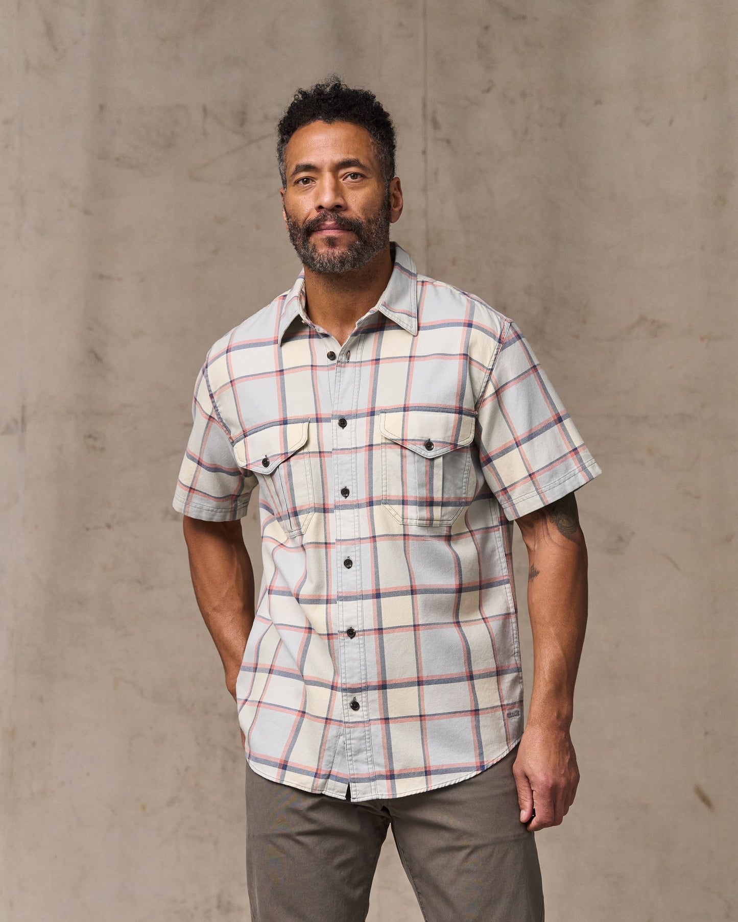 image of a model wearing Filson's Short Sleeve Lightweight Alaskan Guide Shirt  - Light Blue / Tan Plaid|Model is 6'2" wearing a size medium