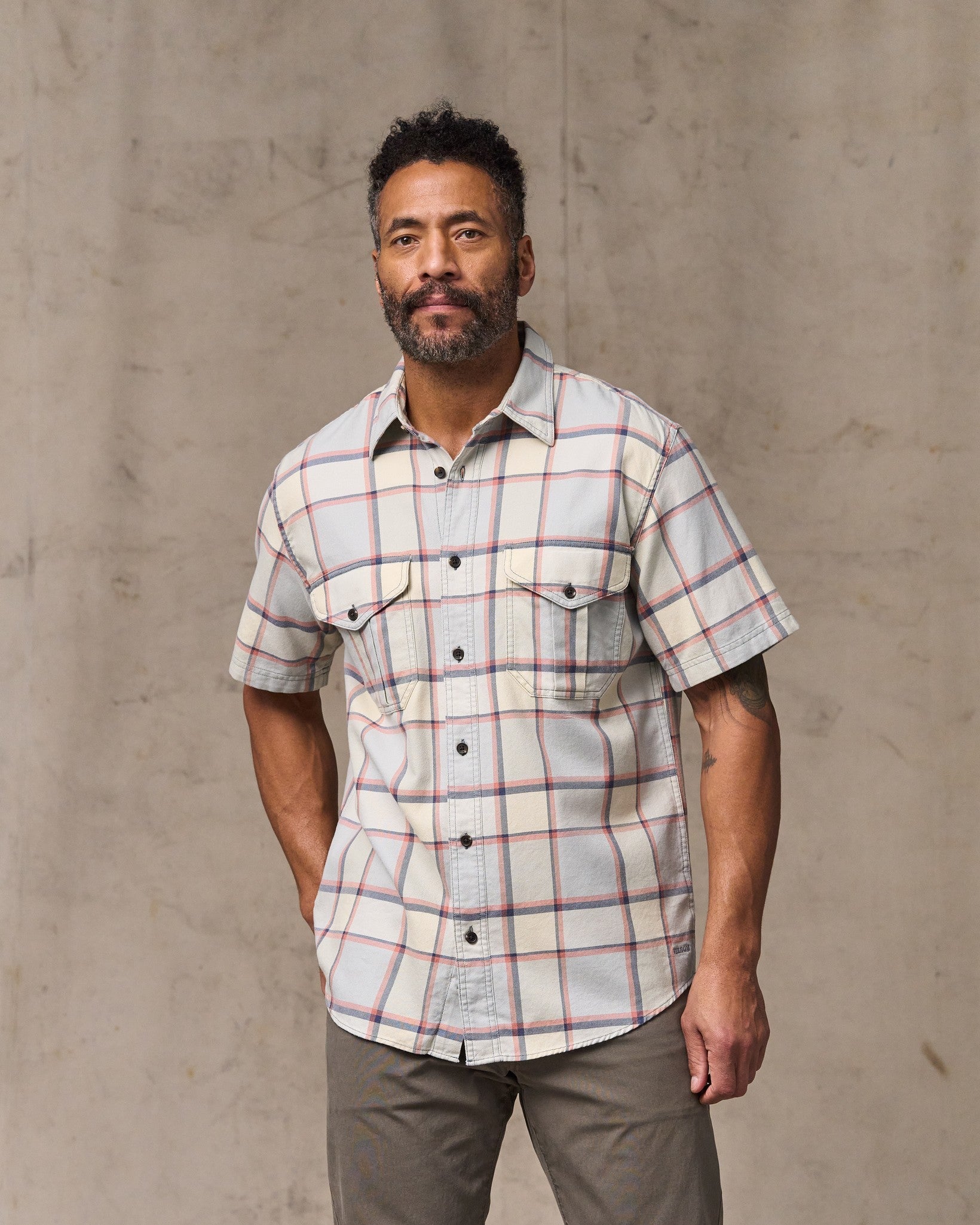 image of a model wearing Filson's Short Sleeve Lightweight Alaskan Guide Shirt  - Light Blue / Tan Plaid