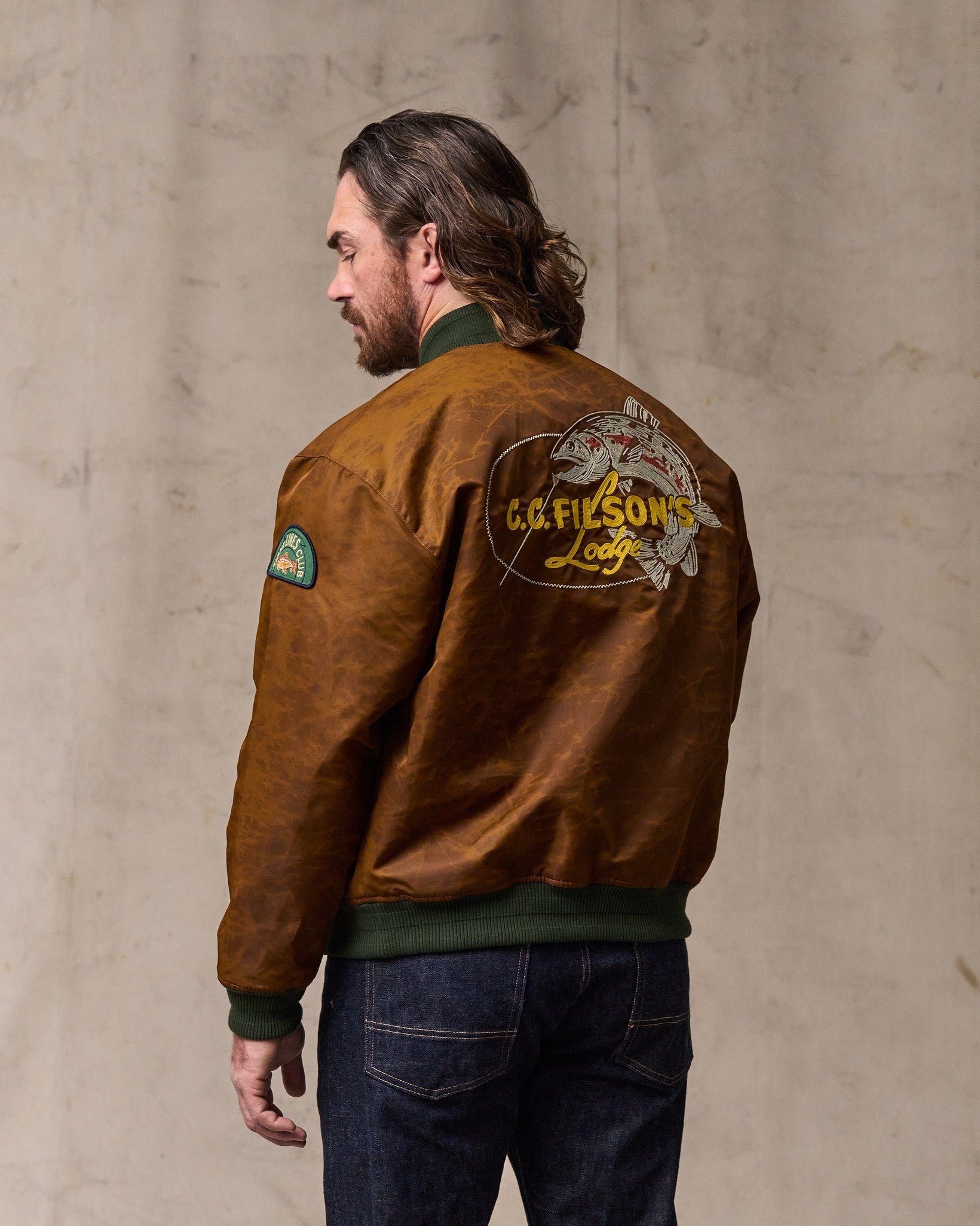image of a model wearing Filson's Embroidered Montlake Jacket - Whiskey