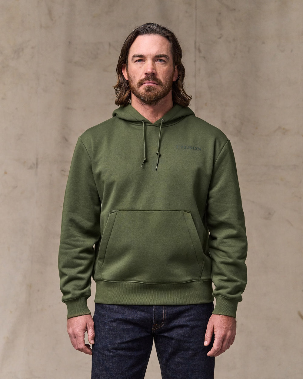 image of a model wearing Filson's Scenic Graphic Hoodie - Surplus Green