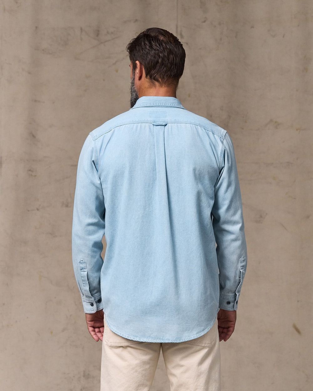 image of a model wearing Filson's Denim Guide Shirt - Light Indigo