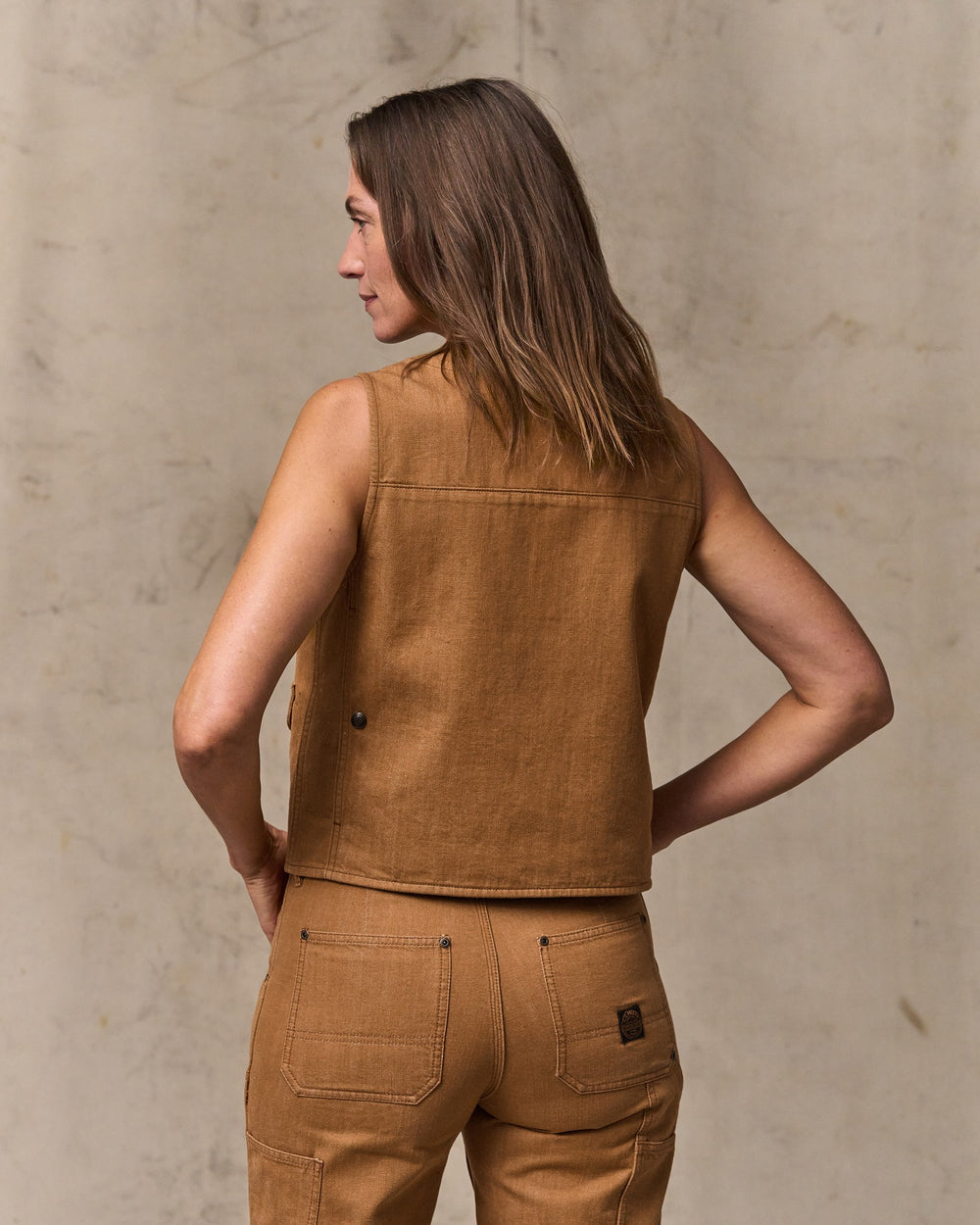 image of a model wearing Filson's Women's Archive Cruiser Vest - Harvest Tan