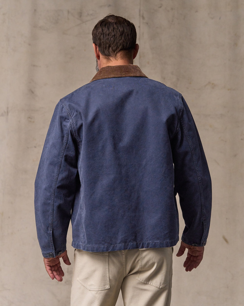 image of a model wearing Filson's Canvas Outfitter Jacket - Blue Mussel