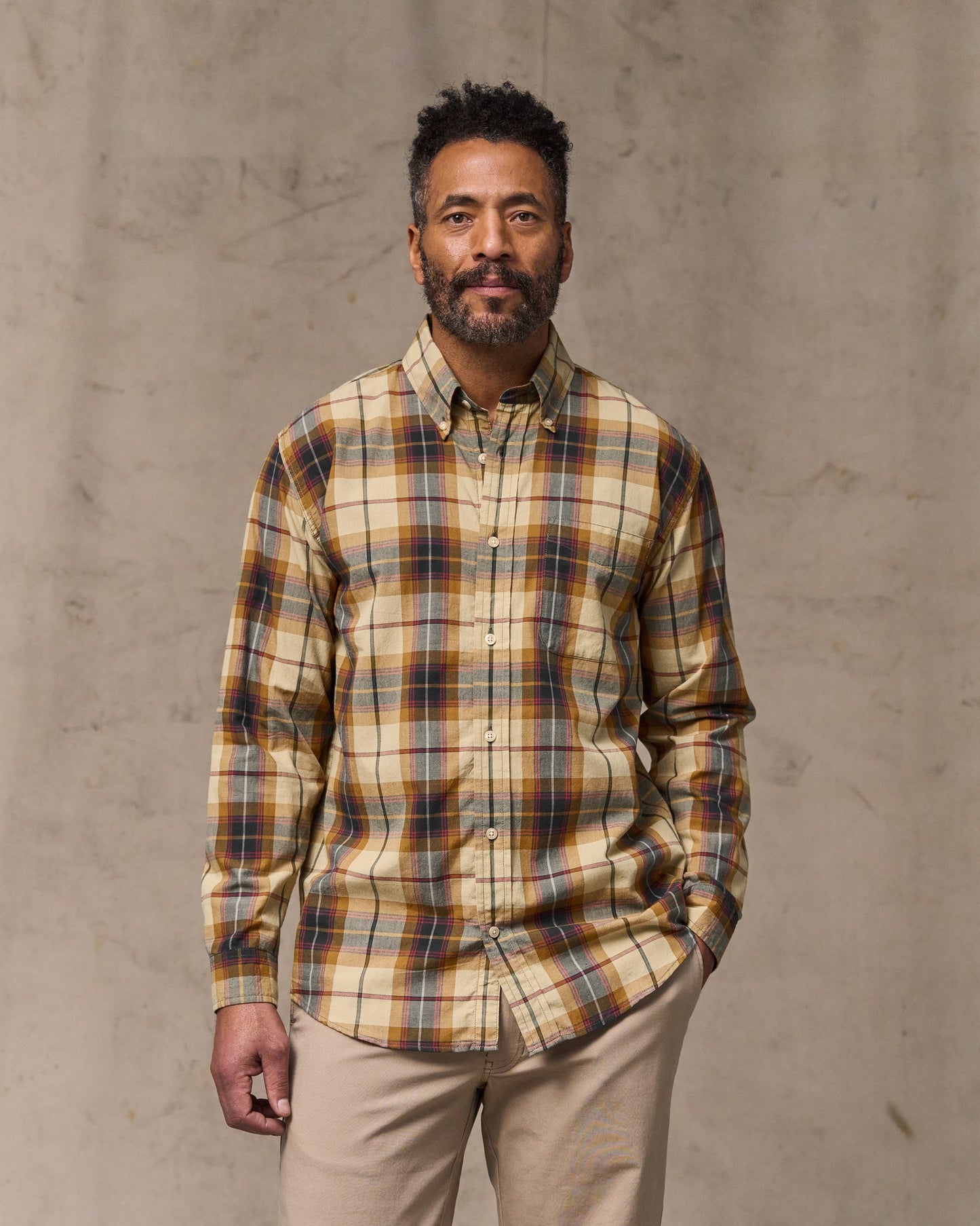 image of a model wearing Filson's Madras Button-down Shirt - Tan / Spruce Multi|Model is 6'2" wearing a size medium
