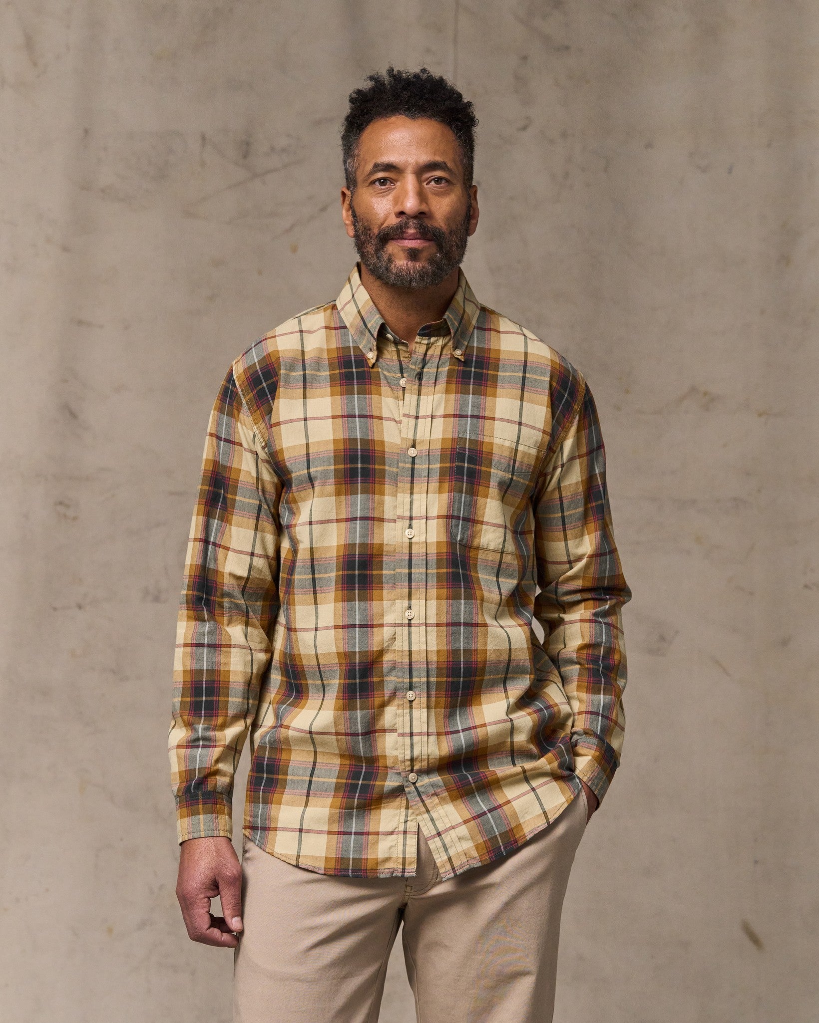 image of a model wearing Filson's Madras Button-down Shirt - Tan / Spruce Multi