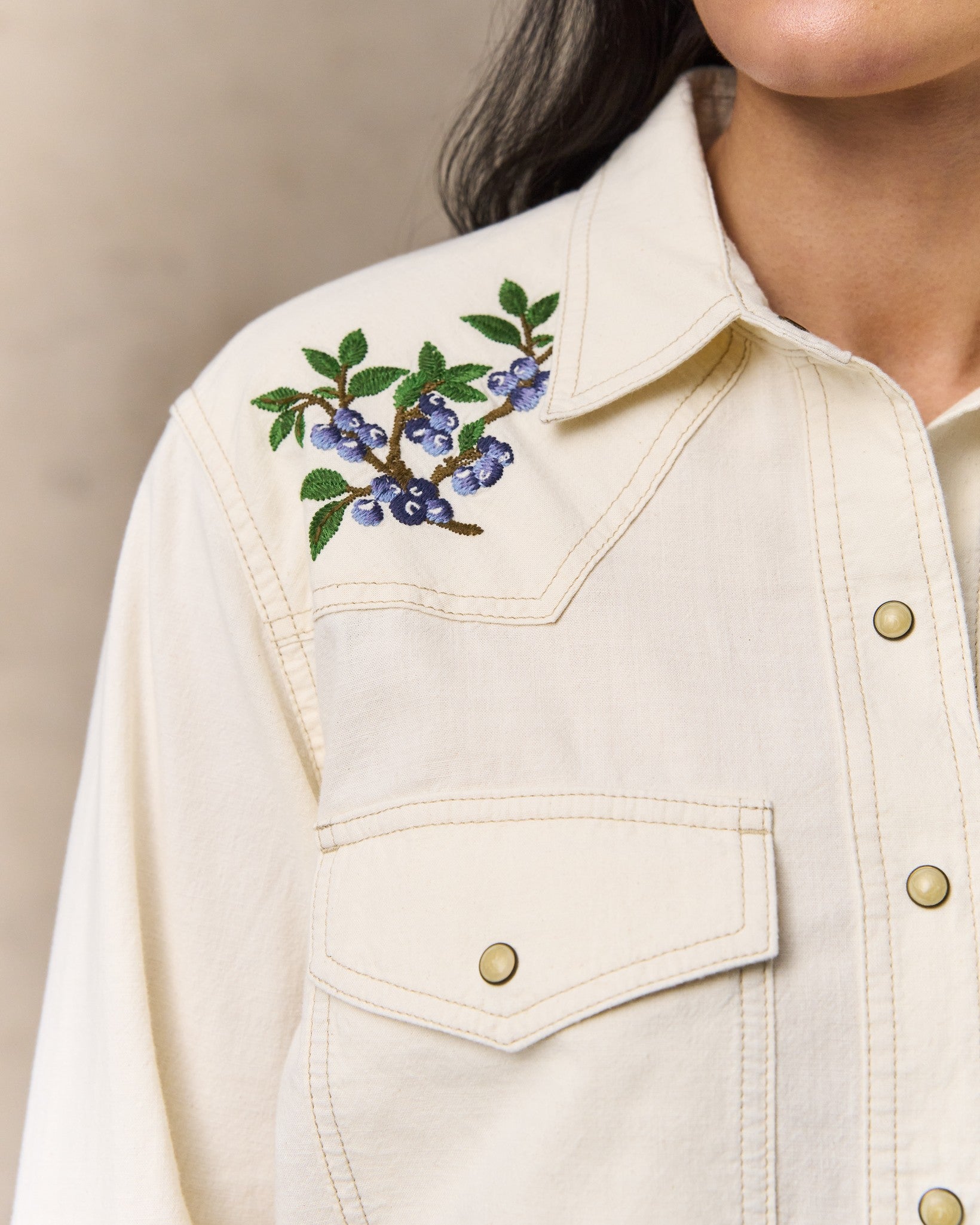 image of a model wearing Filson's Women's Embroidered Western Shirt - Natural Seed