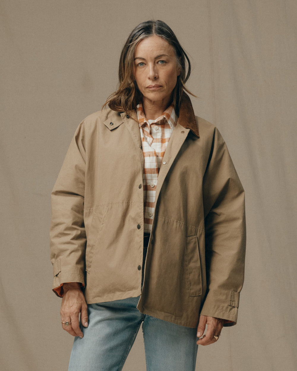 image of a model wearing Filson's Women's Harbor Front Waxed Jacket - Marsh Tan