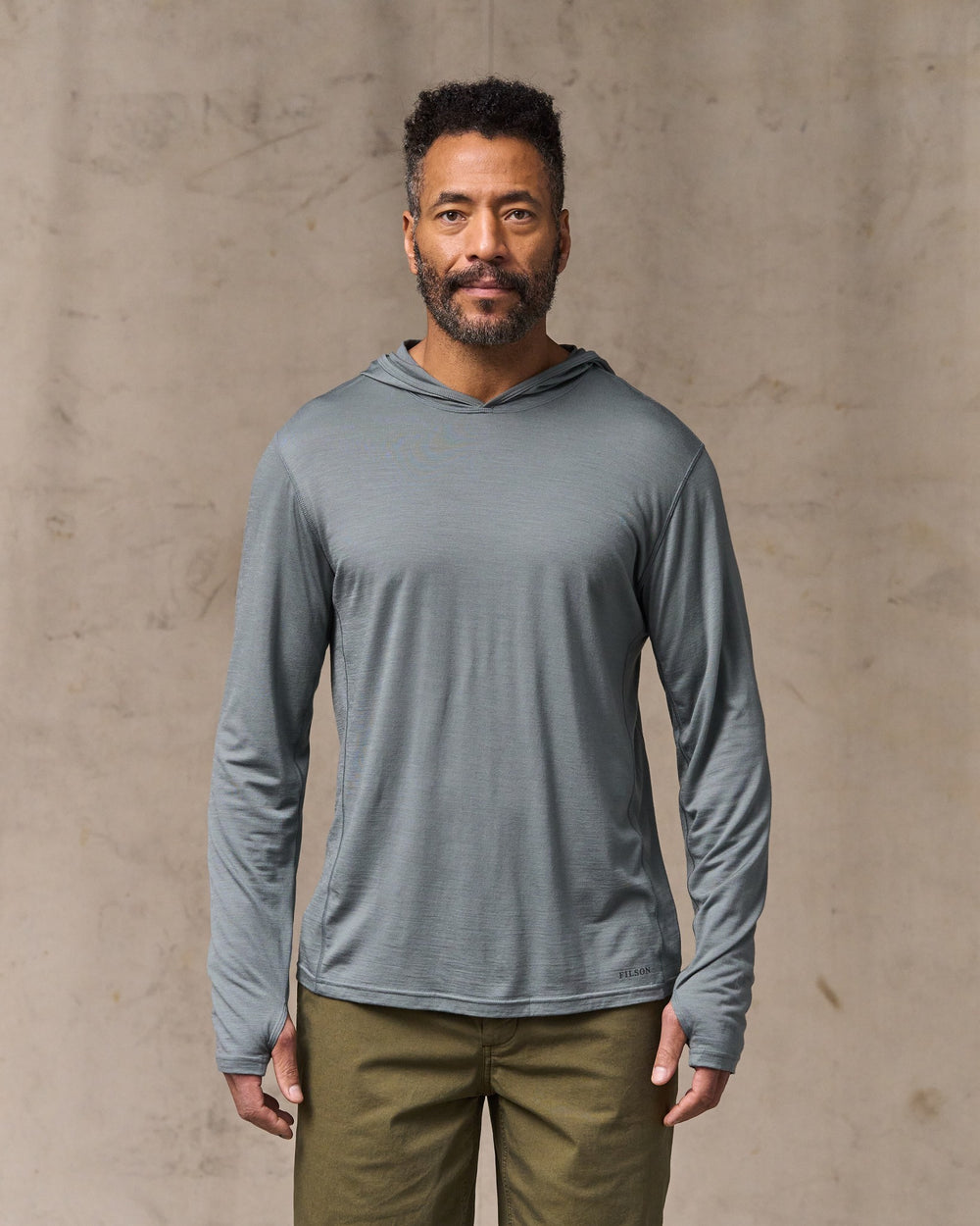 image of a model wearing Filson's Wool-blend Upf Hoodie - Sage Gray
