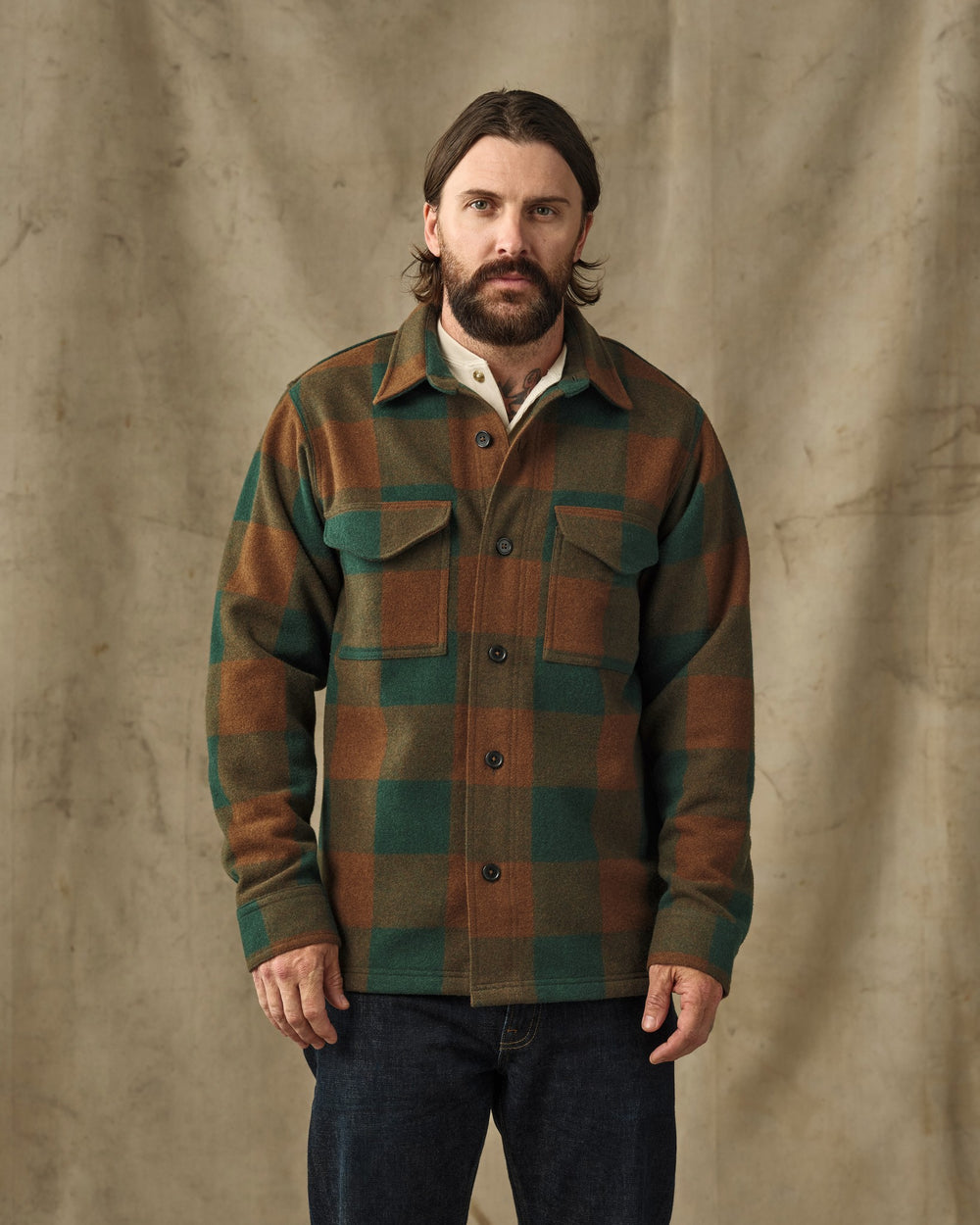 image of a model wearing Filson's Wool Jac-Shirt - Bronze / Green Plaid